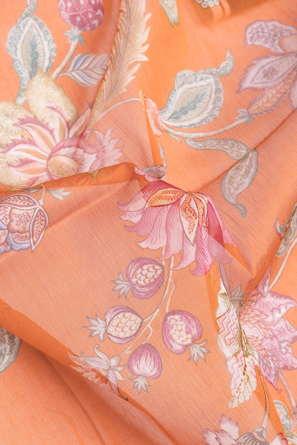 Close up of Orange Mysore Chiffon Saree with Floral Print on the body and Without Border.  displaying folds