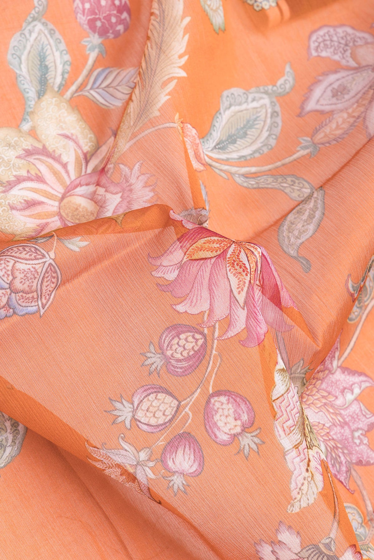 Close up of Orange Mysore Chiffon Saree with Floral Print on the body and Without Border.  displaying folds