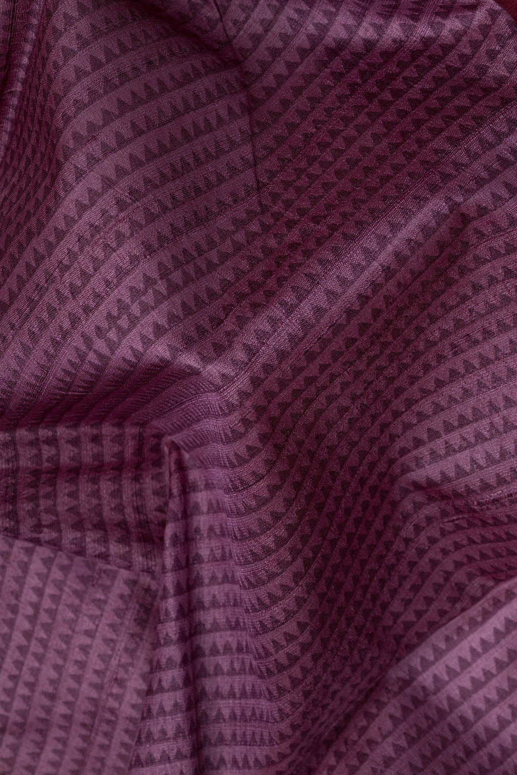 Close up of Purple Dual Tone Tussar Silk Saree with Printed design on the body and Fancy Border.  displaying folds
