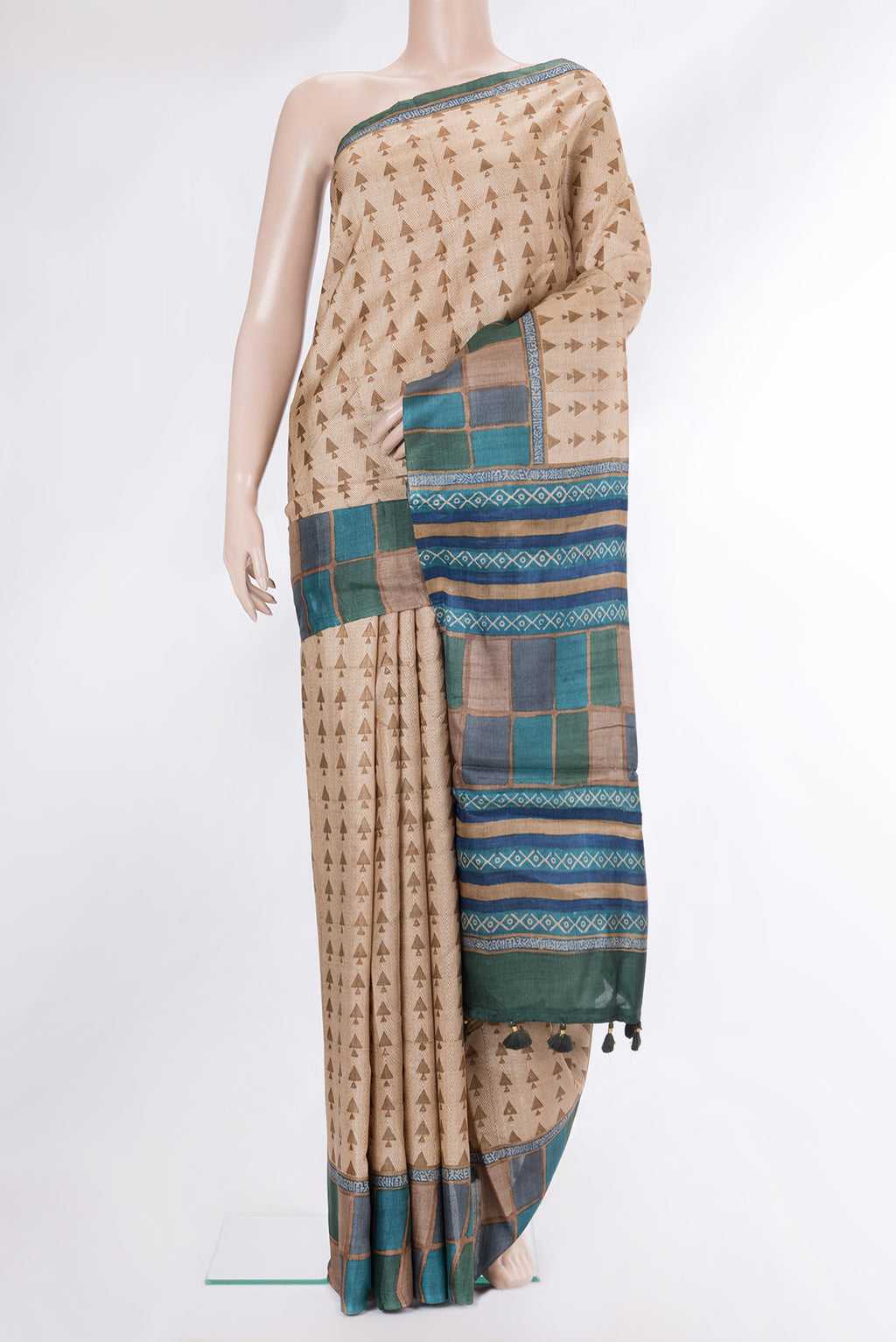 Beige Tussar Saree with Printed design on the body and Fancy Border.  displayed on a mannequin
