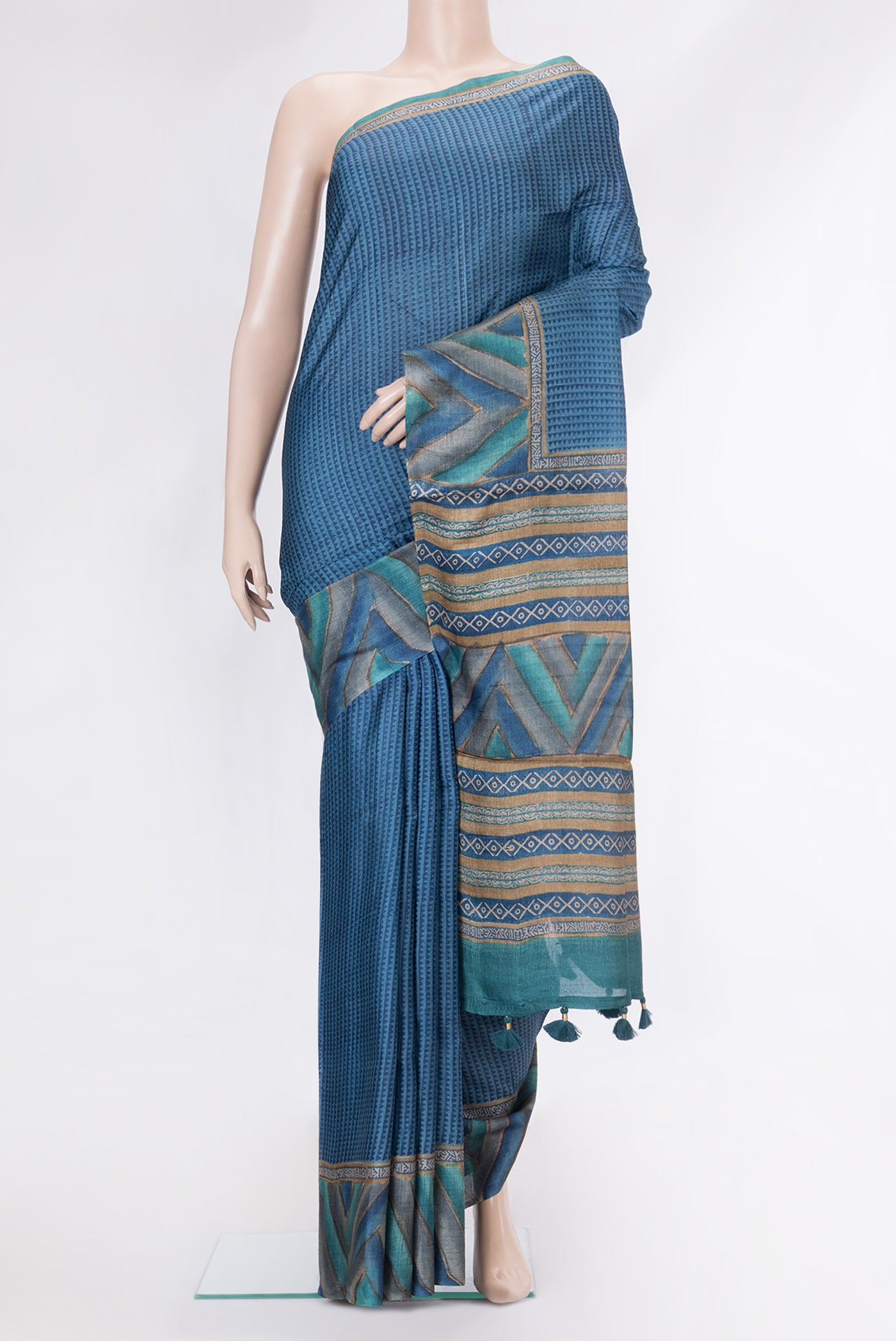 Peacock Blue Dual Tone Tussar Silk Saree with Printed design on the body and Fancy Border.  displayed on a mannequin