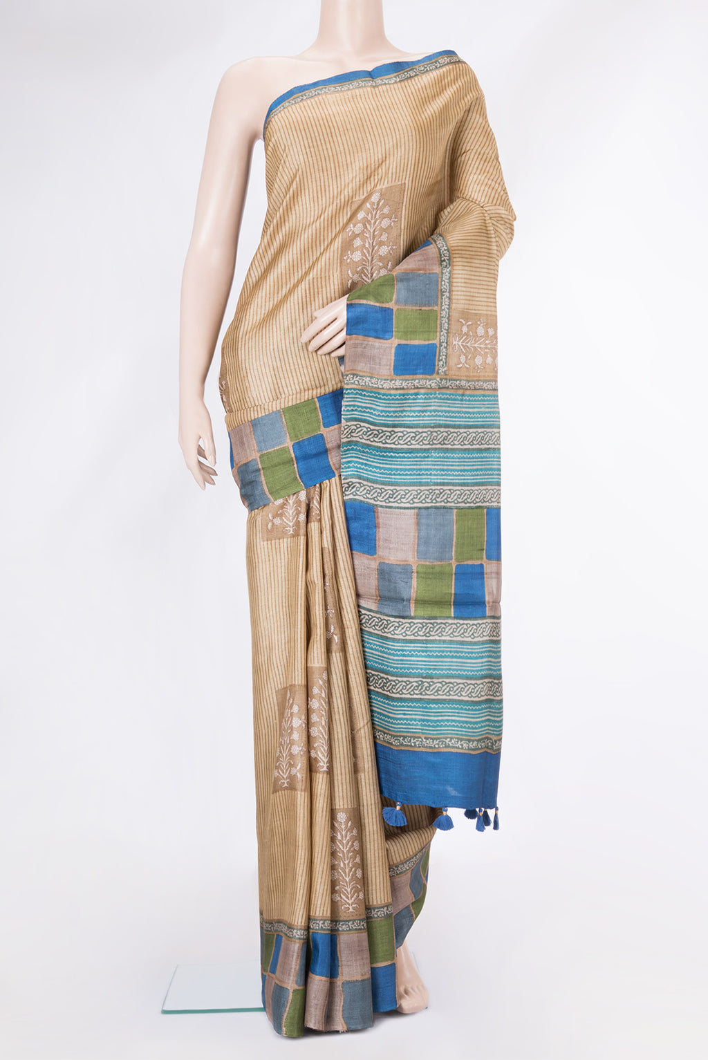 Beige Tussar Silk Saree with Printed design on the body and Printed Border.  displayed on a mannequin