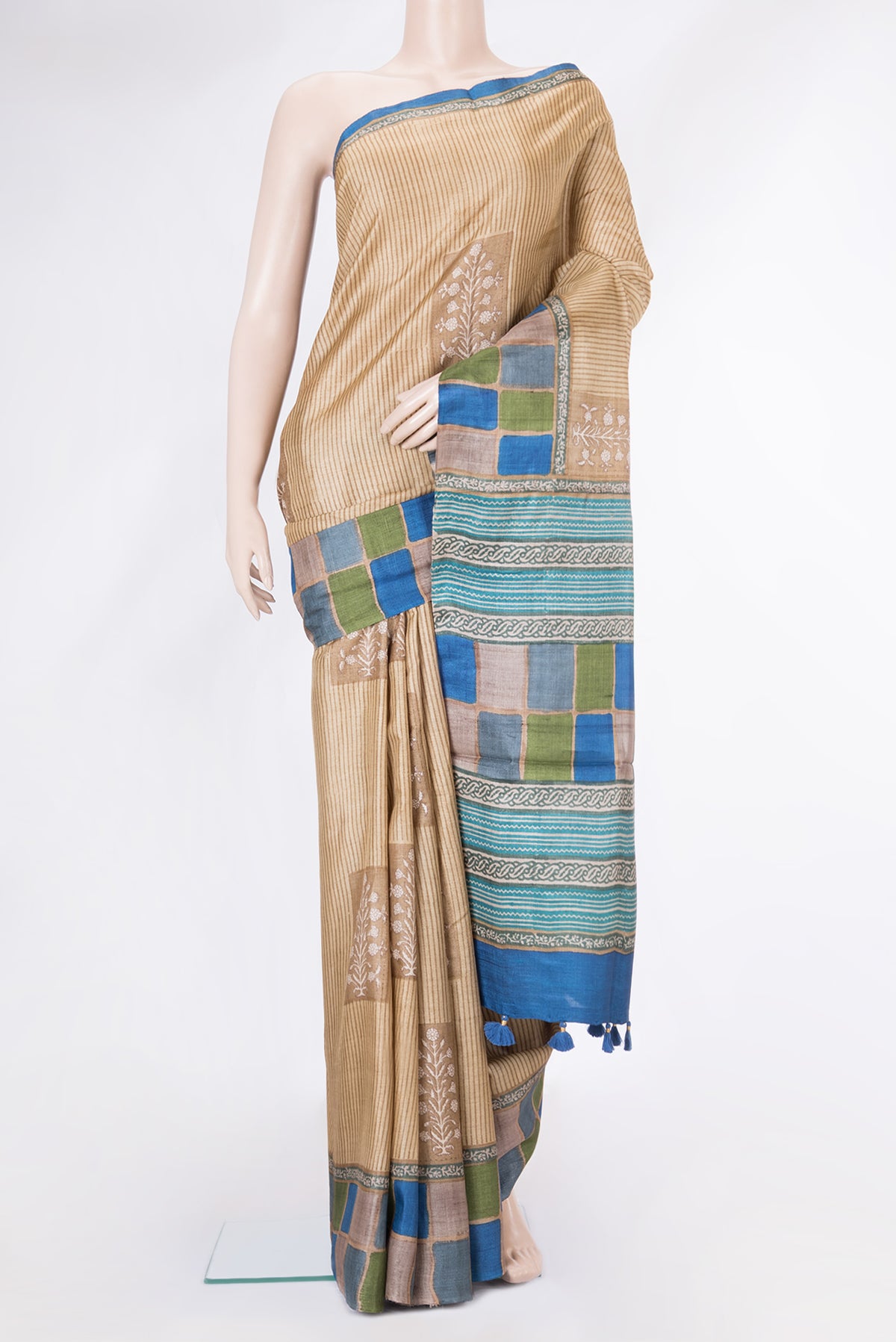 Beige Tussar Silk Saree with Printed design on the body and Printed Border.  displayed on a mannequin