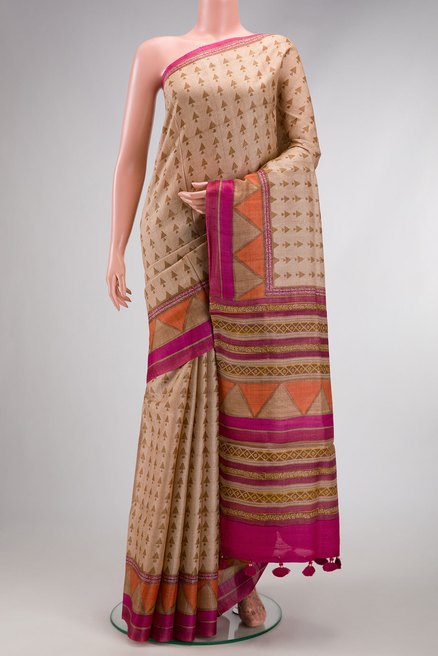 Beige Dual Tone Tussar Silk Saree with Printed design on the body and Fancy Border.  displayed on a mannequin