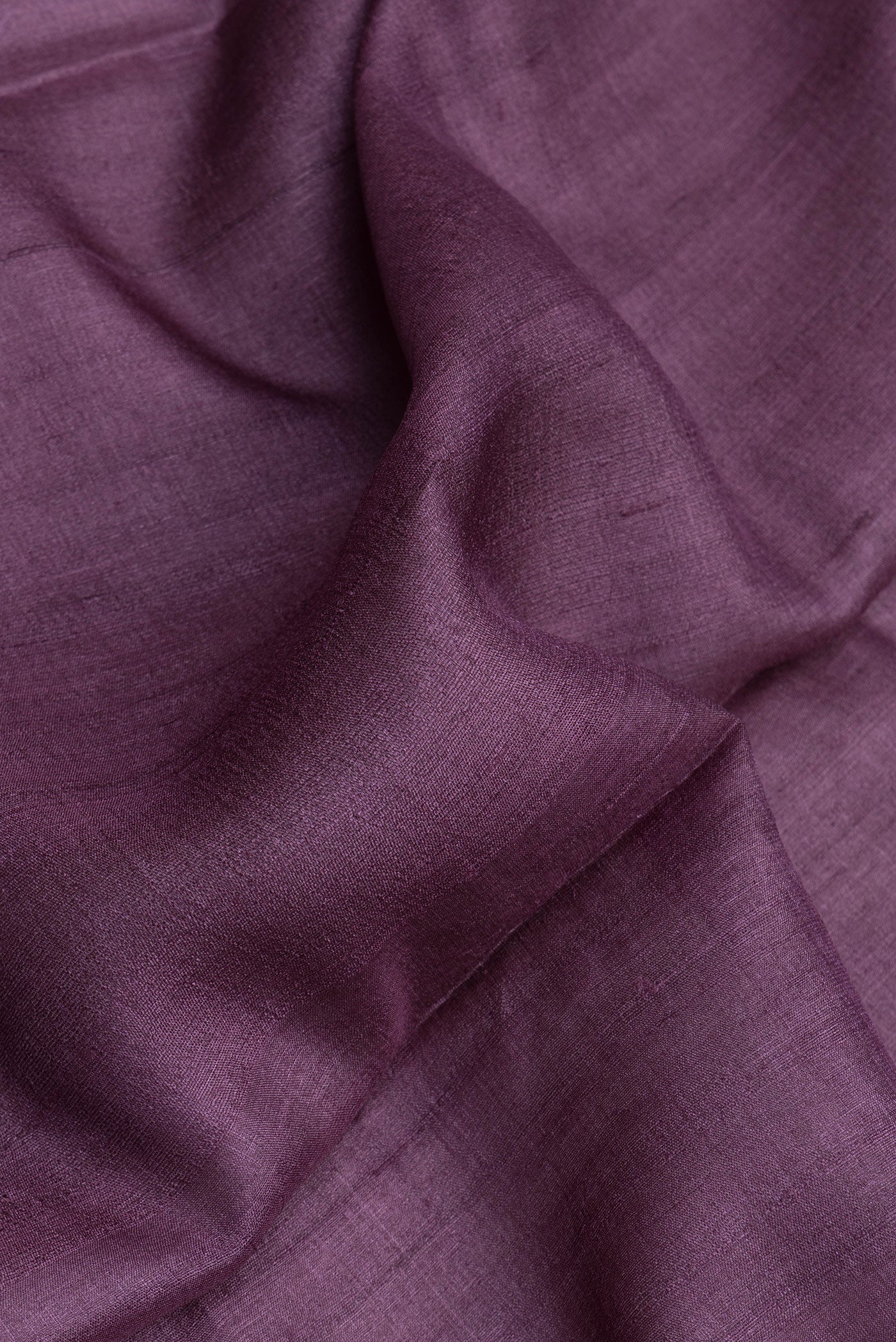 Close up of Purple Dual Tone Tussar Silk Saree with Plain Body and Fancy Border.  displaying folds