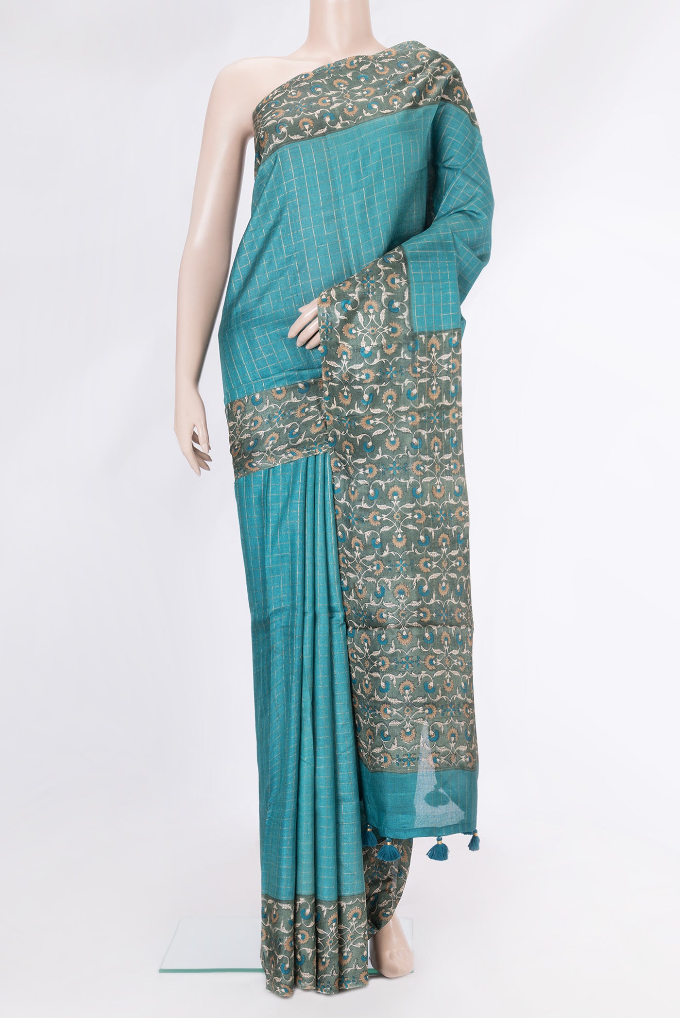 Peacock Blue Dual Tone Tussar Silk Saree with Checked design on the body and Printed Border.  displayed on a mannequin