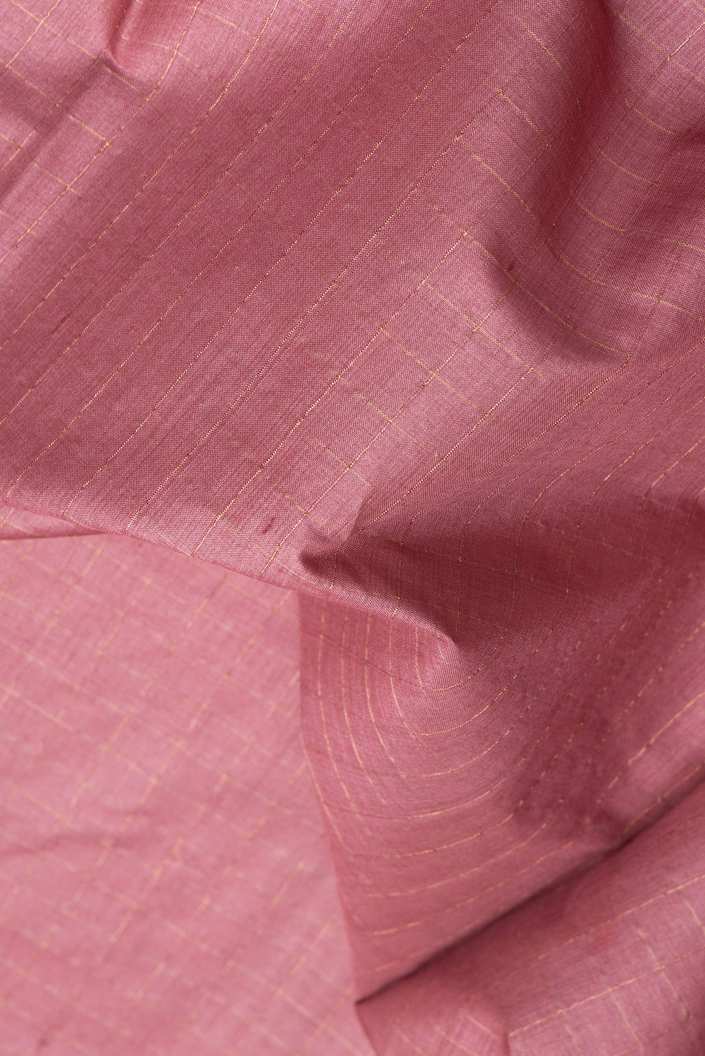Close up of Pink Tussar Silk Saree with Checked design on the body and Fancy Border.  displaying folds