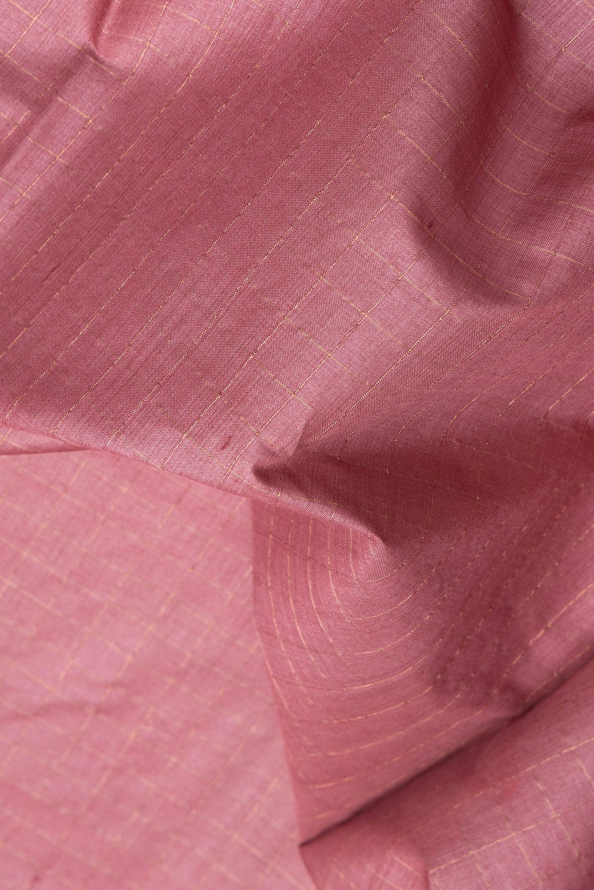 Close up of Pink Tussar Silk Saree with Checked design on the body and Fancy Border.  displaying folds