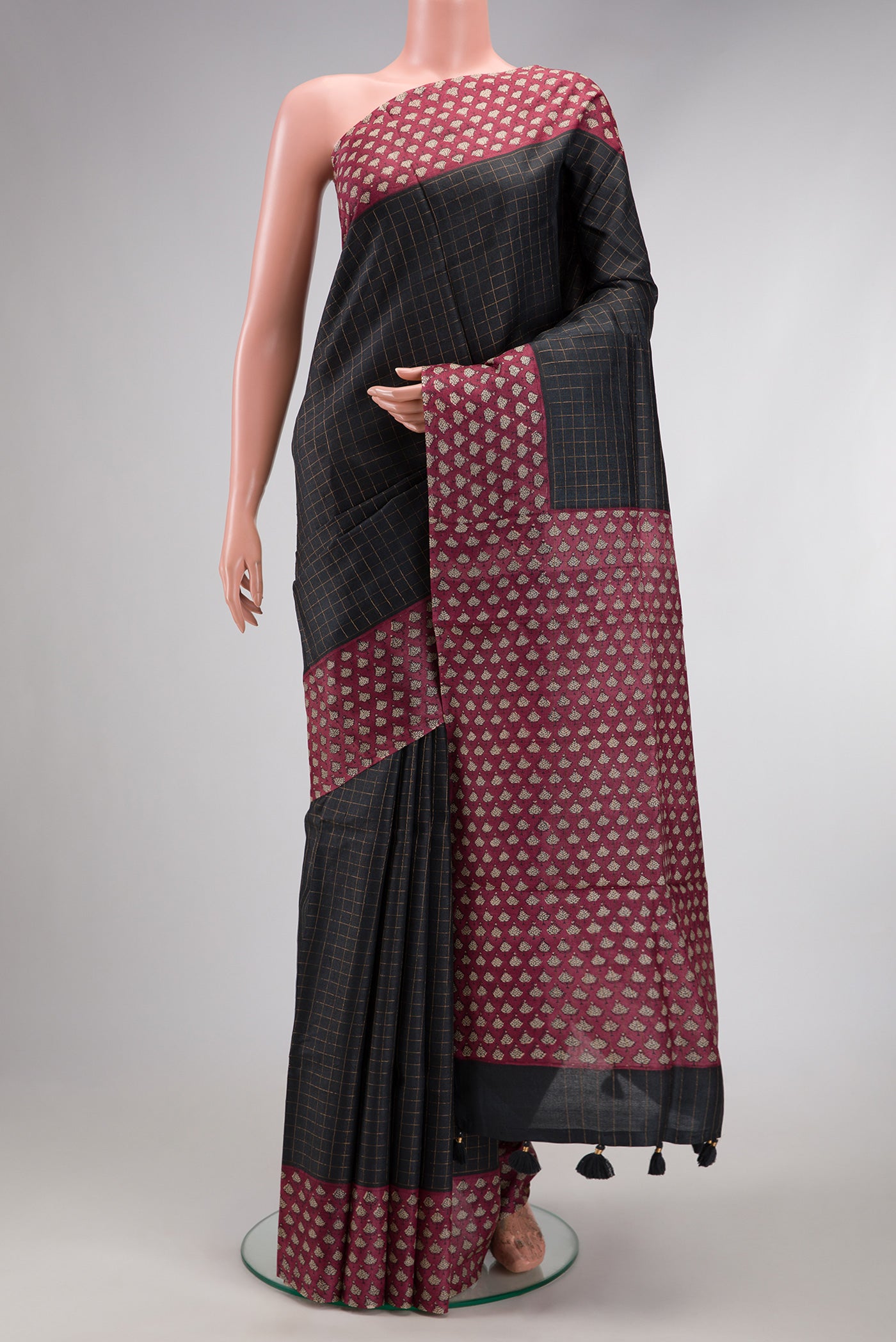 Black Dual Tone Tussar Silk Saree with Checked design on the body and Printed Border.  displayed on a mannequin