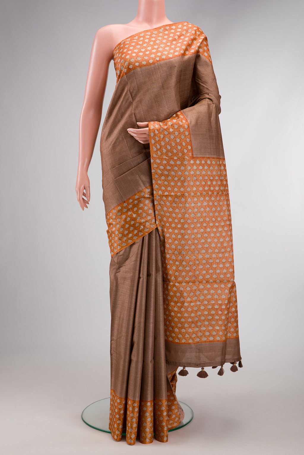 Brown Dual Tone Tussar Silk Saree with Checked design on the body and Printed Border.  displayed on a mannequin
