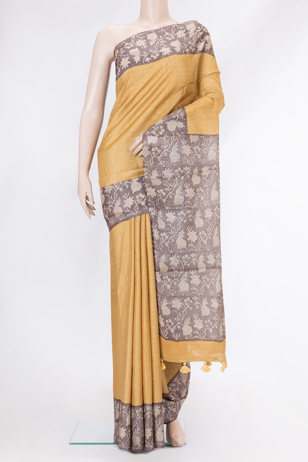 Gold Dual Tone Tussar Silk Saree with Checked design on the body and Printed Border.  displayed on a mannequin