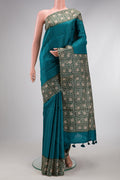 Peacock Blue Dual Tone Tussar Silk Saree with Checked design on the body and Printed Border.  displayed on a mannequin