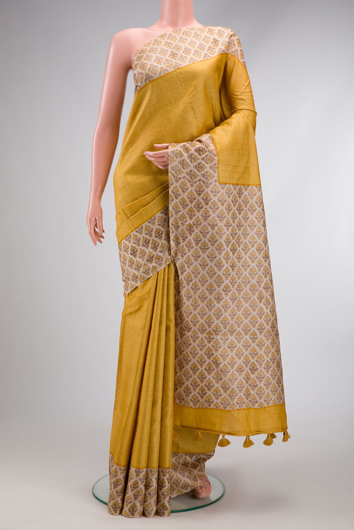 Mustard Dual Tone Tussar Silk Saree with Checked design on the body and Printed Border.  displayed on a mannequin