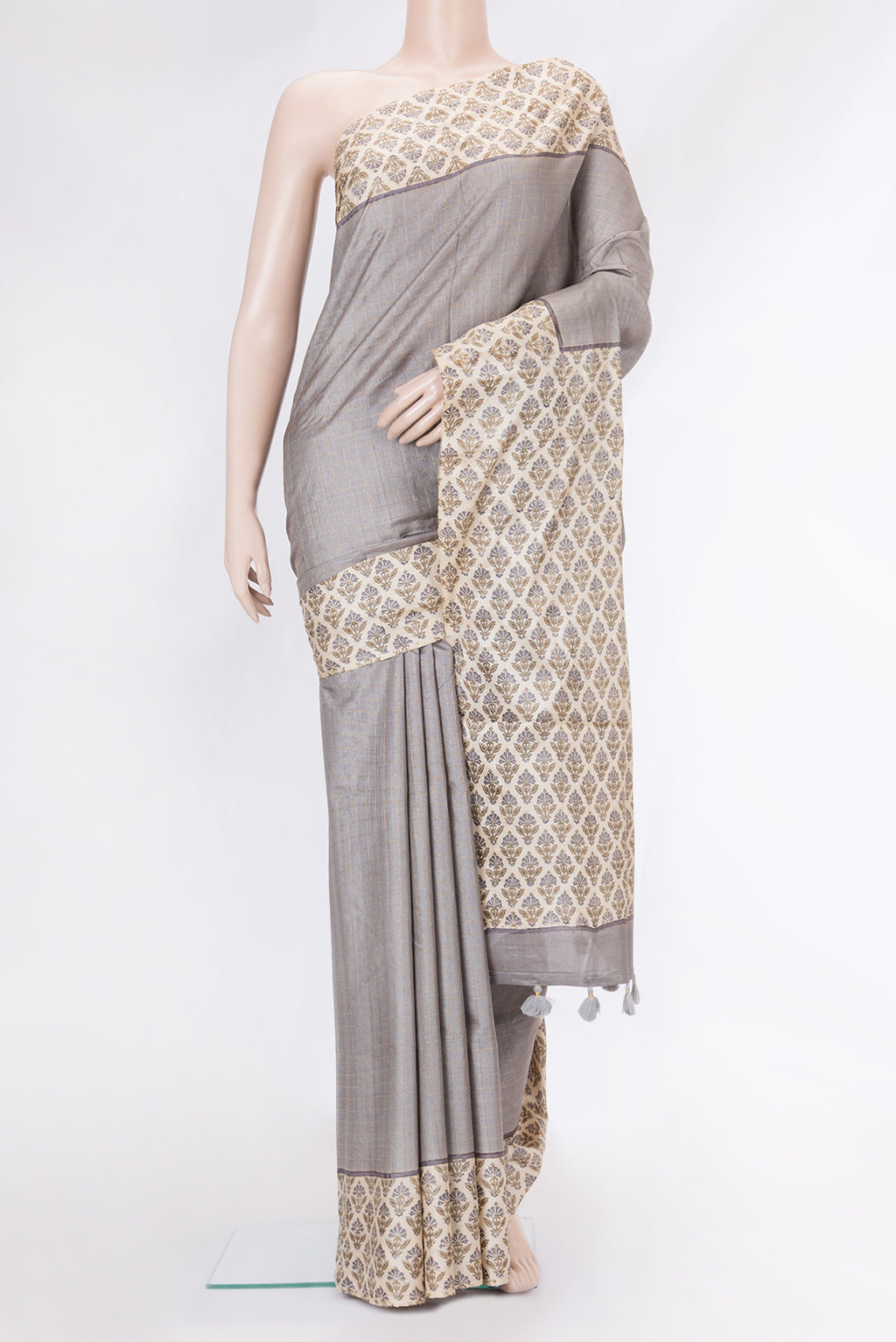 Grey Dual Tone Tussar Silk Saree with Checked design on the body and Printed Border.  displayed on a mannequin