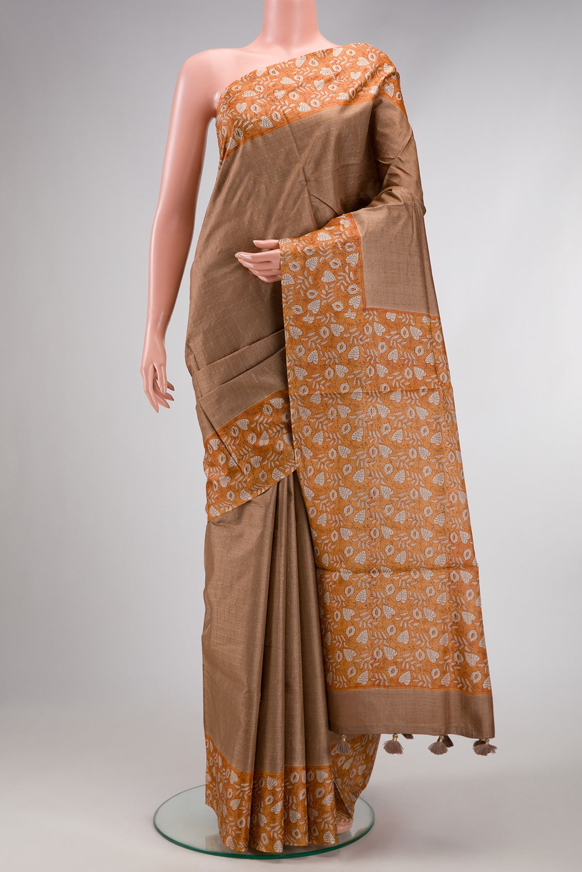 Brown Dual Tone Tussar Silk Saree with Checked design on the body and Printed Border.  displayed on a mannequin