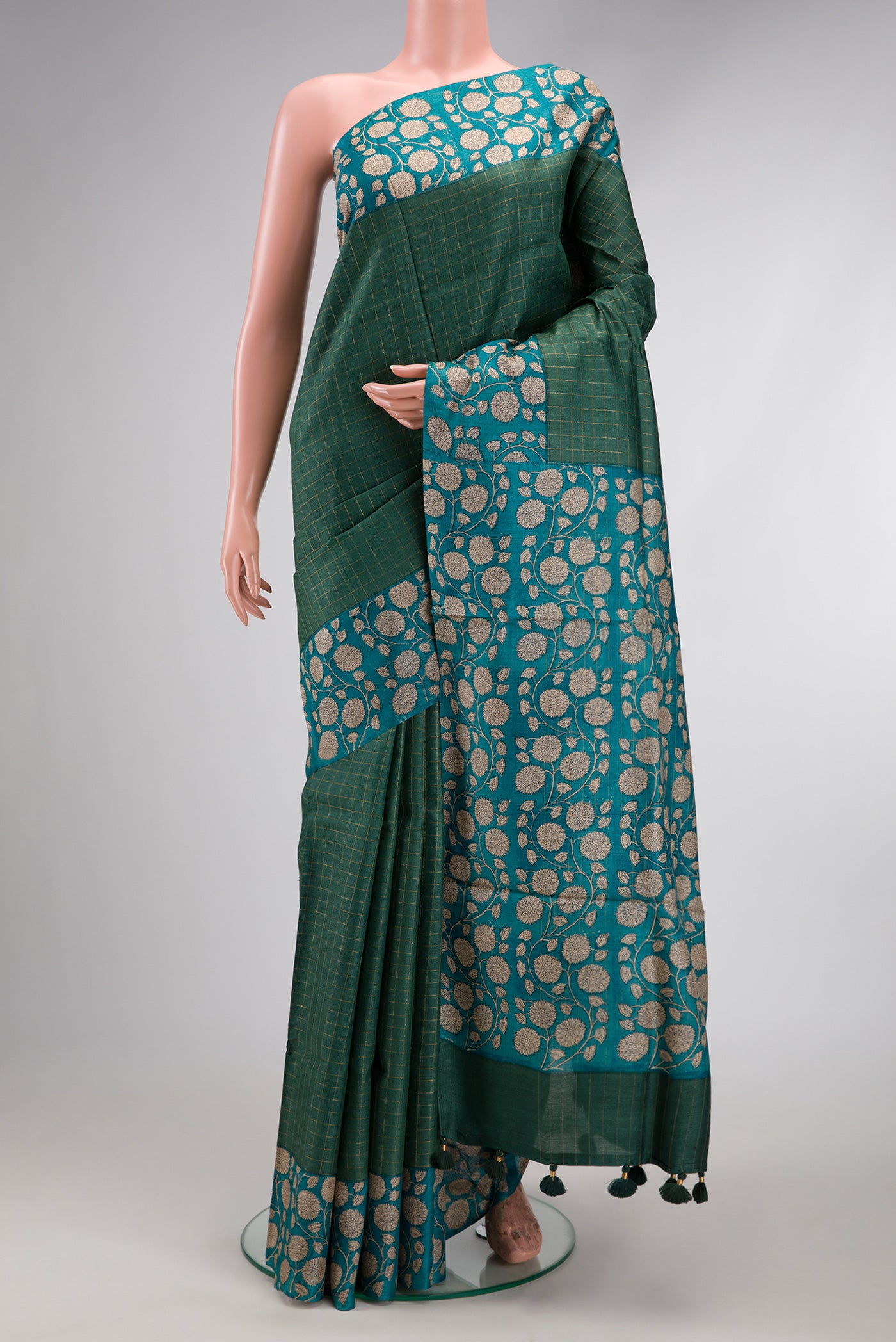 Green Dual Tone Tussar Silk Saree with Checked design on the body and Printed Border.  displayed on a mannequin