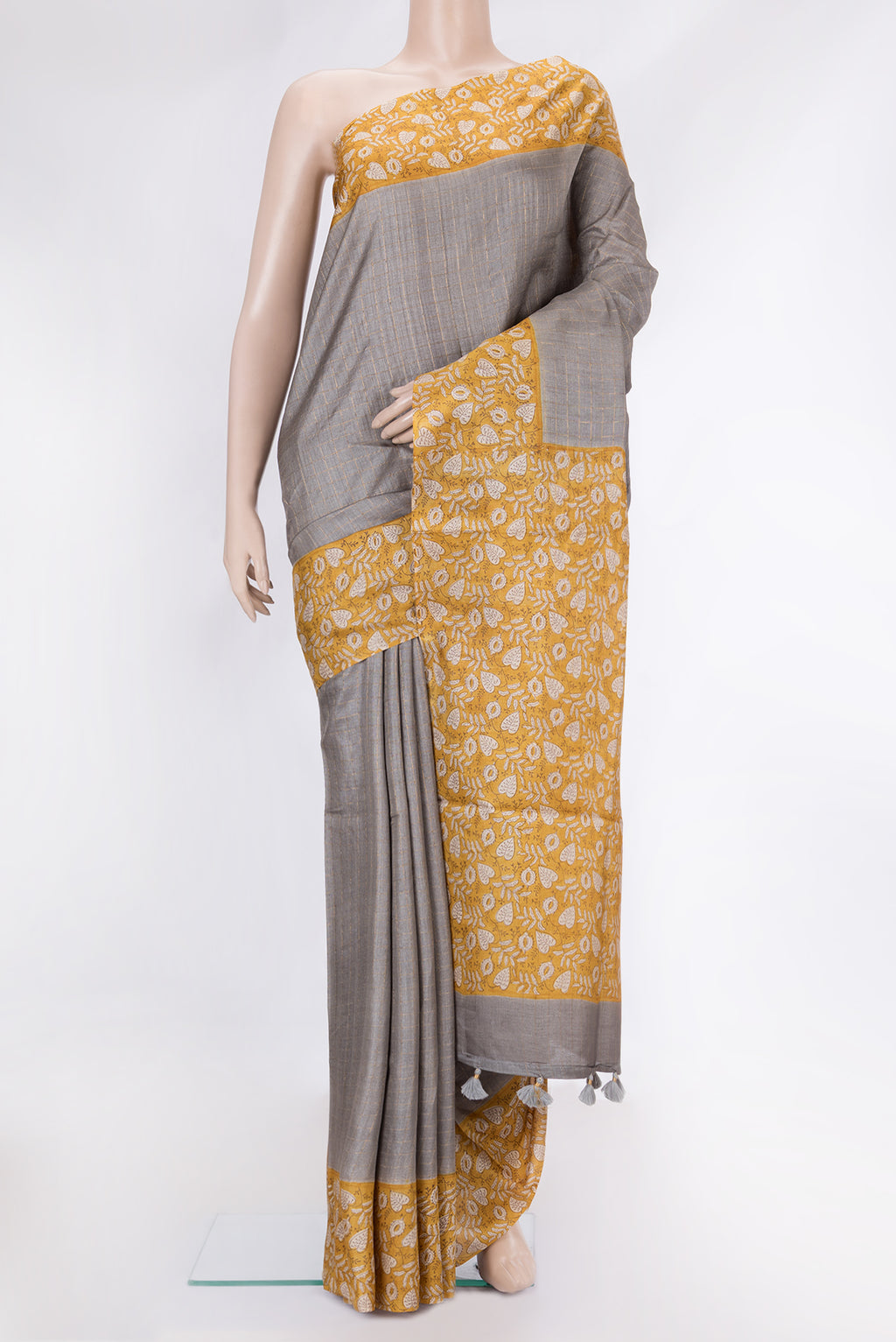 Grey Dual Tone Tussar Silk Saree with Checked design on the body and Printed Border.  displayed on a mannequin