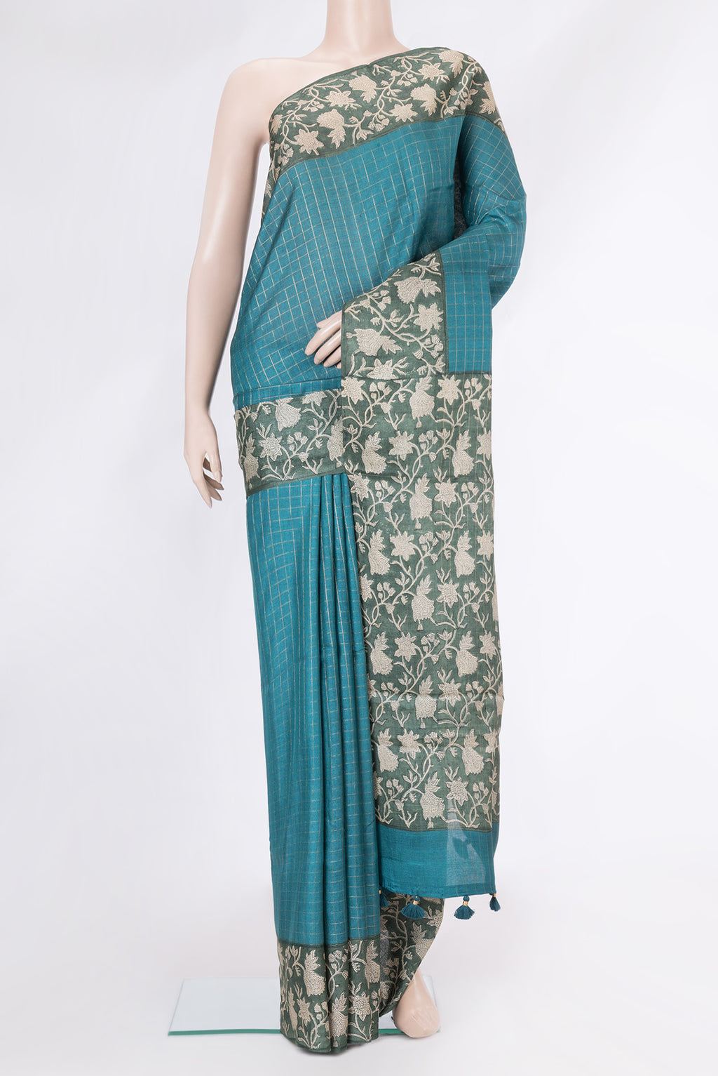 Peacock Blue Dual Tone Tussar Silk Saree with Checked design on the body and Printed Border.  displayed on a mannequin