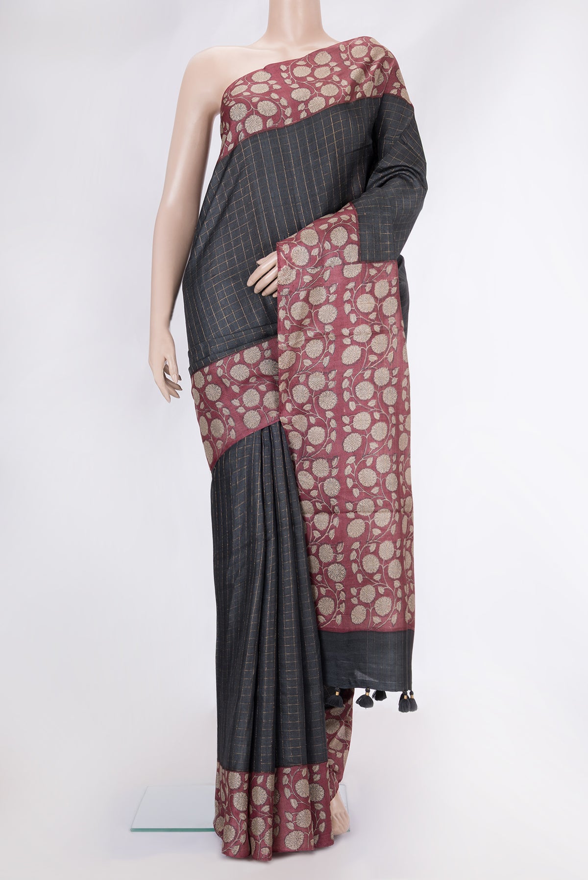 Grey Dual Tone Tussar Silk Saree with Checked design on the body and Printed Border.  displayed on a mannequin
