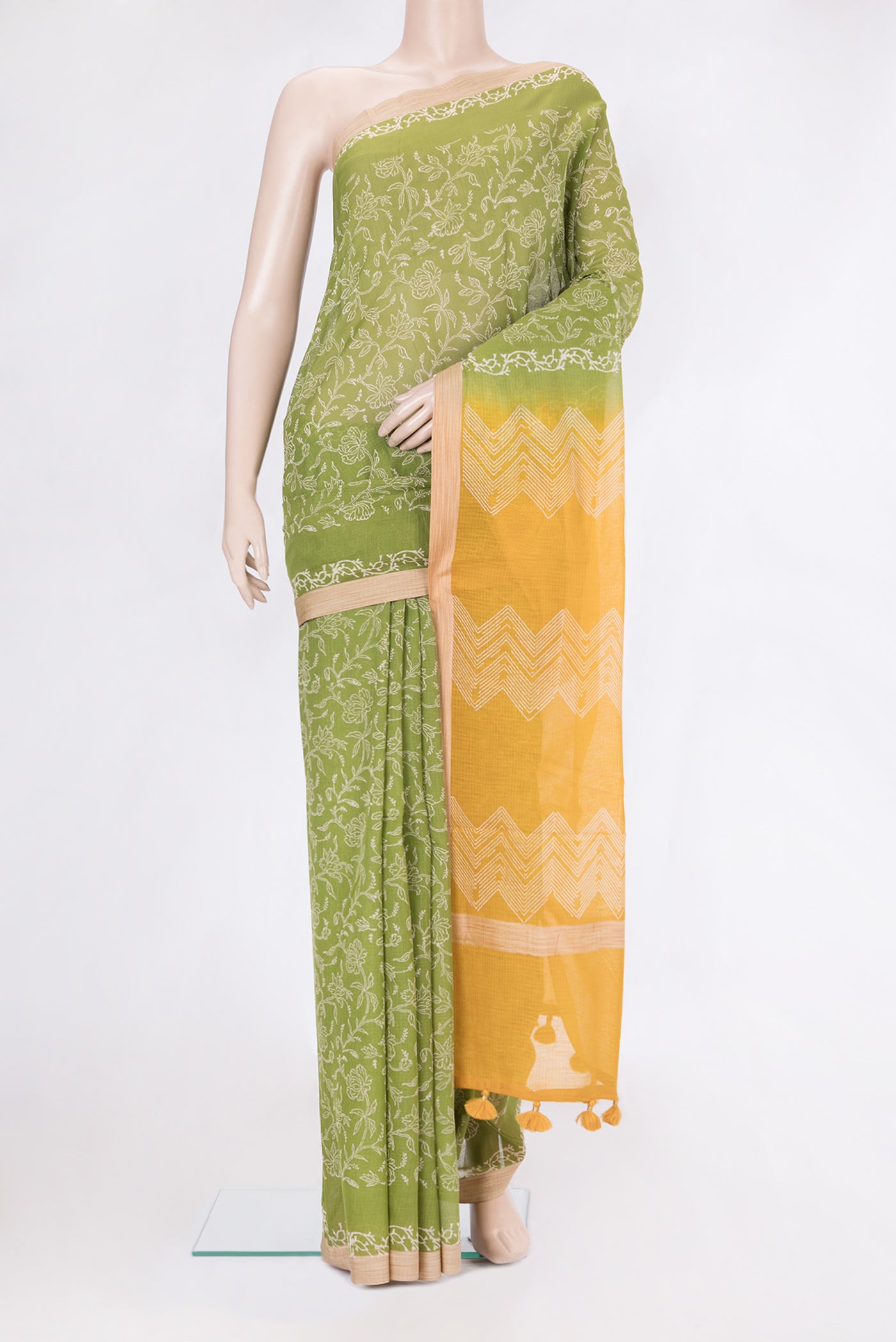 Green Kota Cotton Saree with Printed design on the body and Printed Border.  displayed on a mannequin