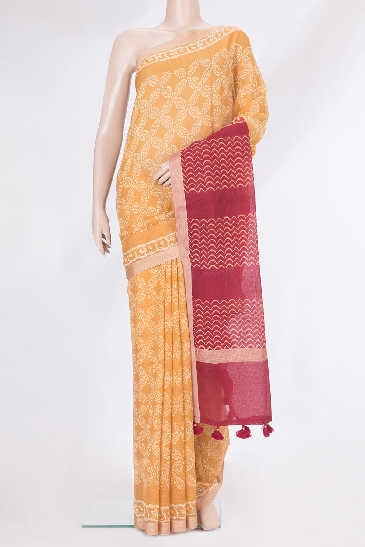 Mustard Kota Silk Saree with Printed design on the body and Printed Border.  displayed on a mannequin