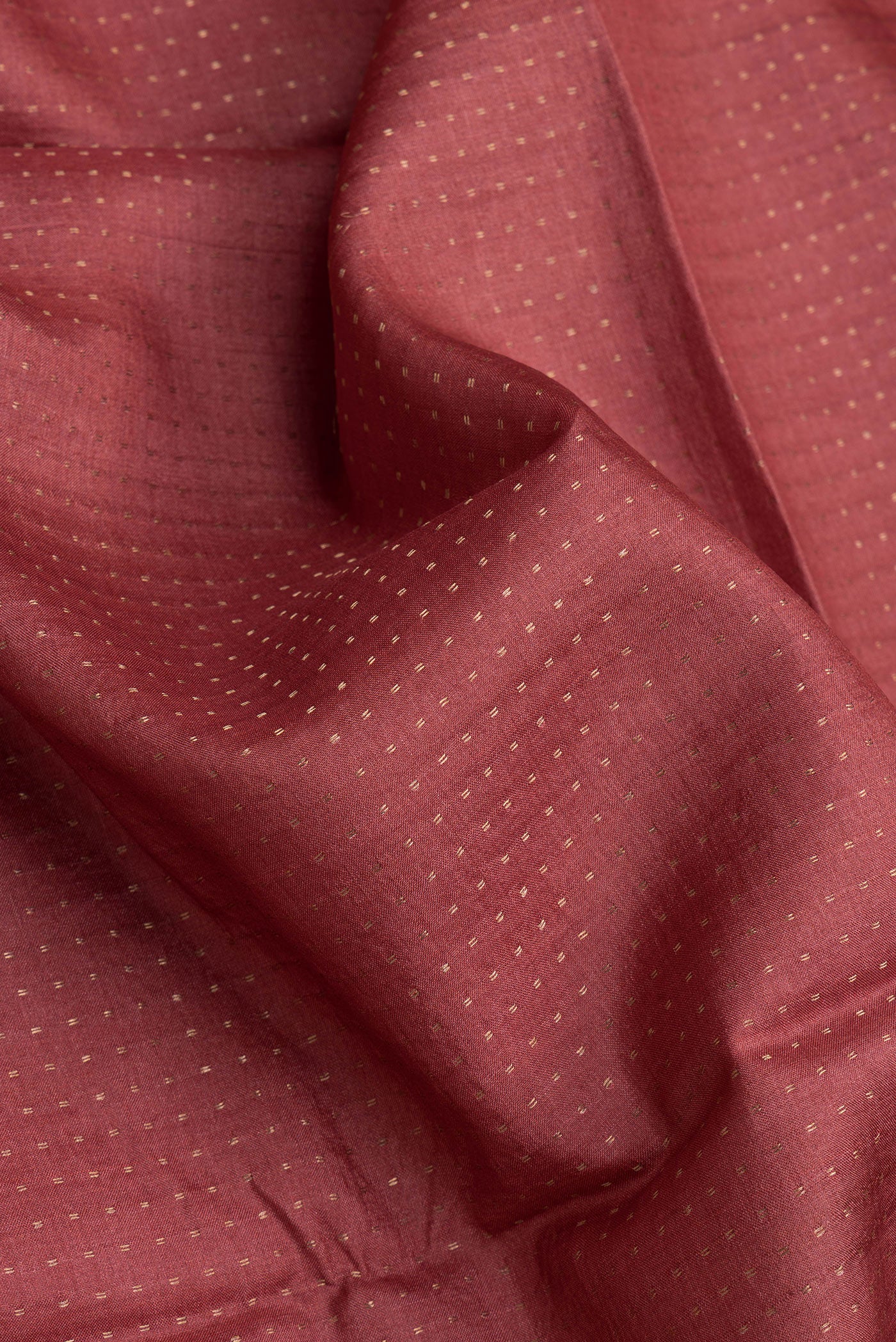 Close up of Maroon Dual Tone Tussar Silk Saree with Stripes on the body and Printed Border.  displaying folds