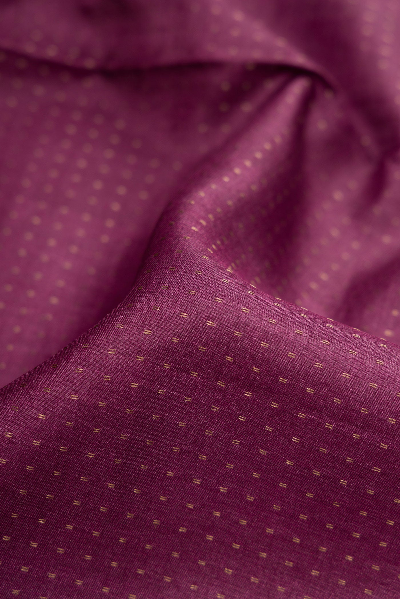 Close up of Magenta Dual Tone Tussar Silk Saree with Stripes on the body and Printed Border.  displaying folds