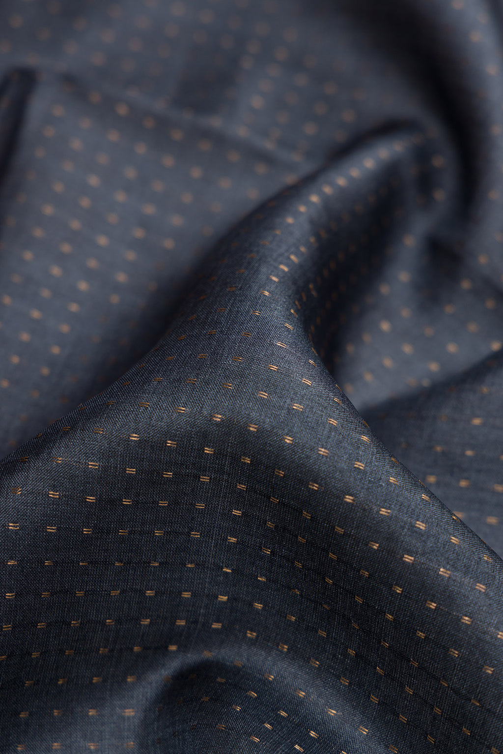Close up of Grey Dual Tone Tussar Silk Saree with Stripes on the body and Printed Border.  displaying folds