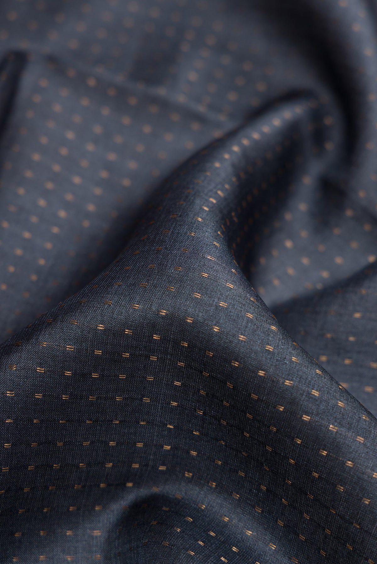 Close up of Grey Dual Tone Tussar Silk Saree with Stripes on the body and Printed Border.  displaying folds