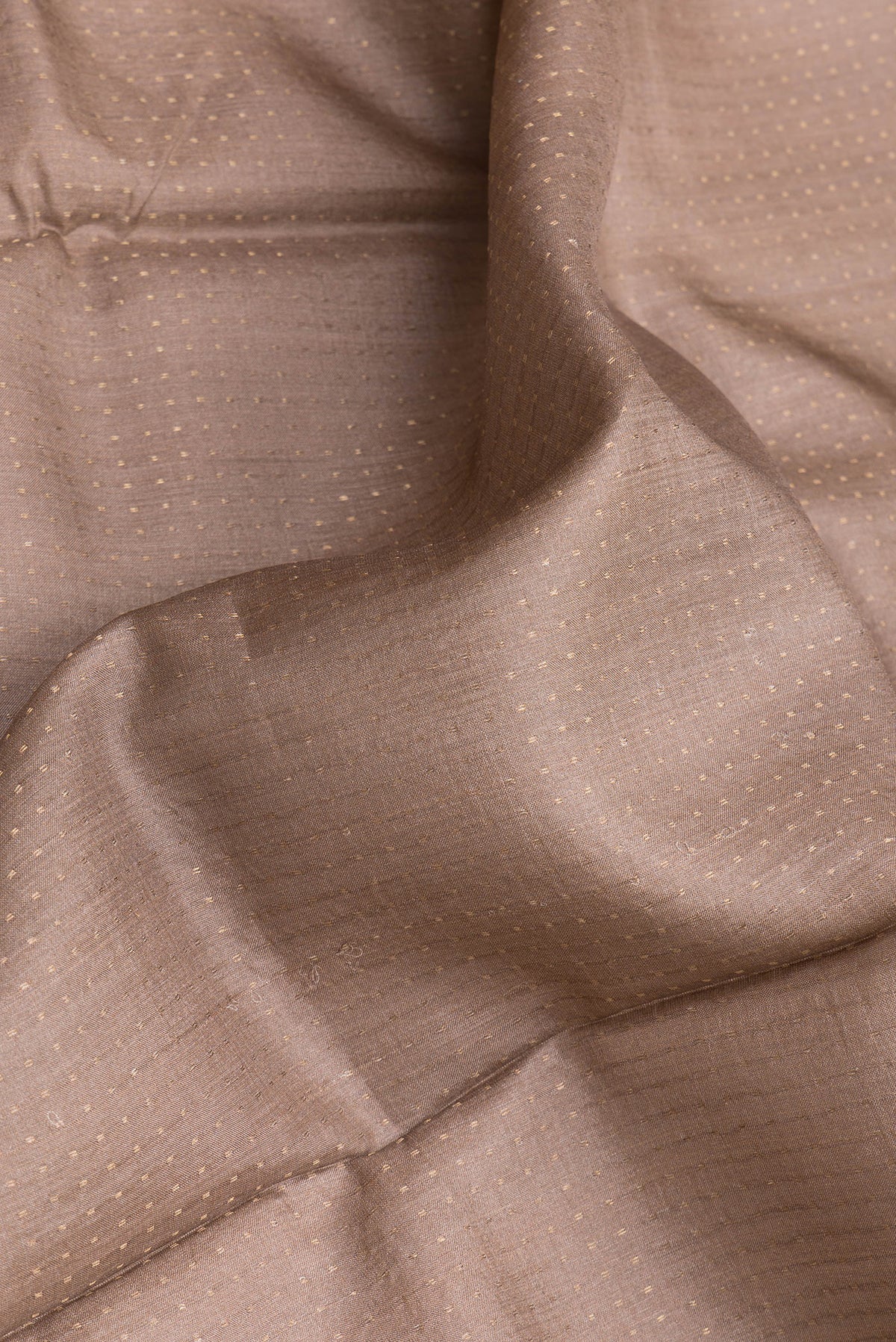 Close up of Brown Dual Tone Tussar Silk Saree with Stripes on the body and Printed Border.  displaying folds