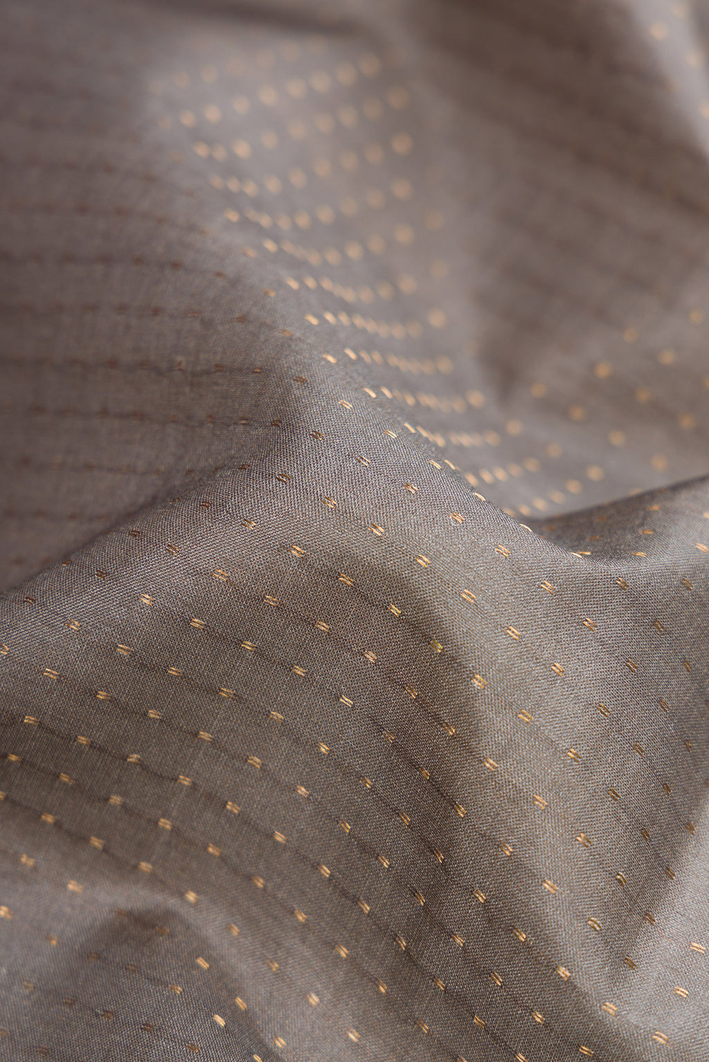 Close up of Grey Dual Tone Tussar Silk Saree with Stripes on the body and Printed Border.  displaying folds