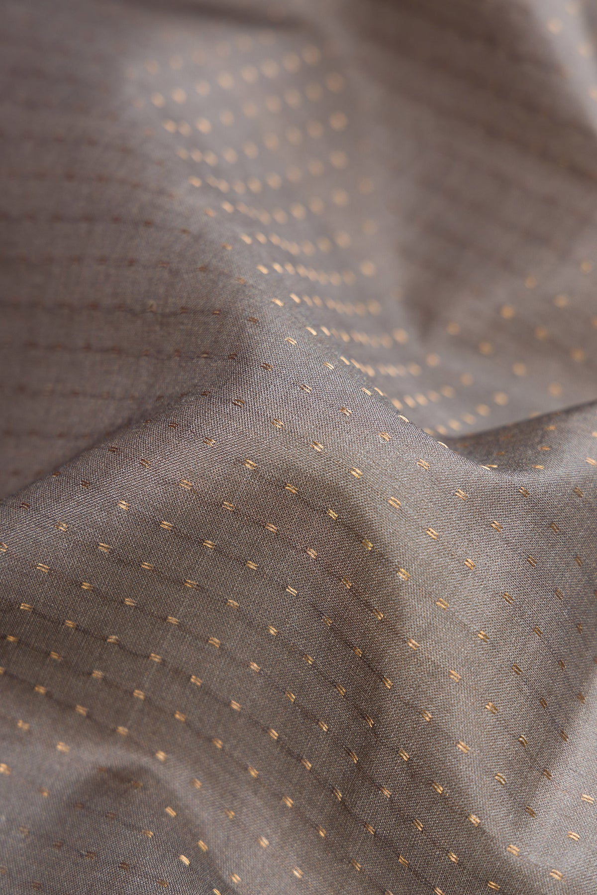 Close up of Grey Dual Tone Tussar Silk Saree with Stripes on the body and Printed Border.  displaying folds