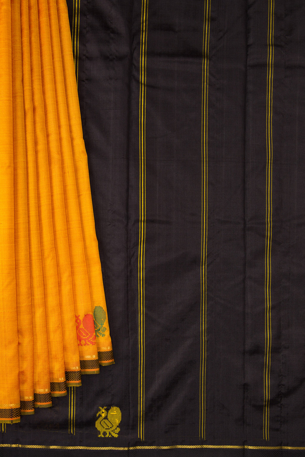 Pleats and pallu of Mustard Kanchipuram Silk Saree with Plain Body and Thread Border. 