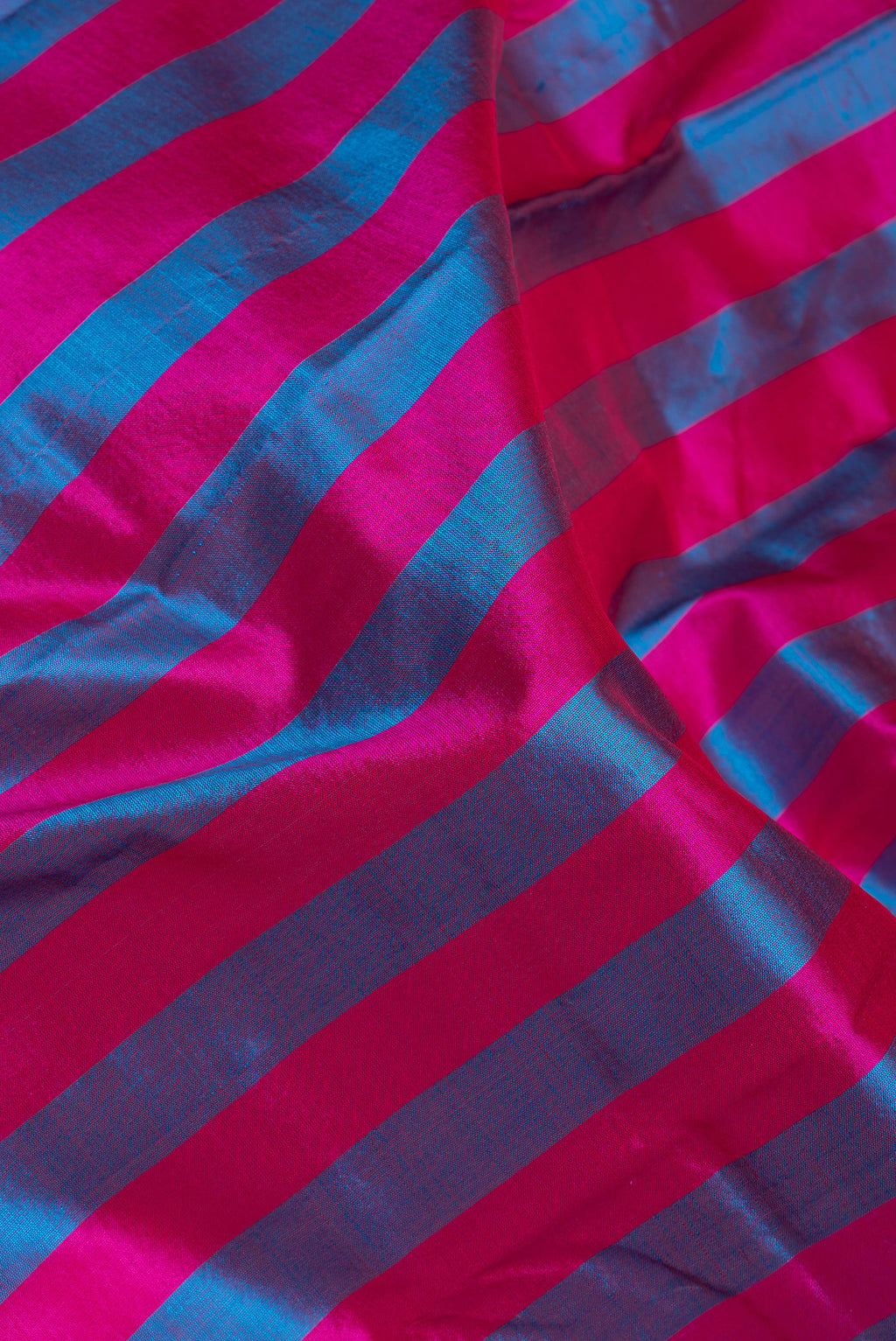Close up of Multi Color Kanchipuram Silk Saree with Stripes on the body and Zari Border.  displaying folds