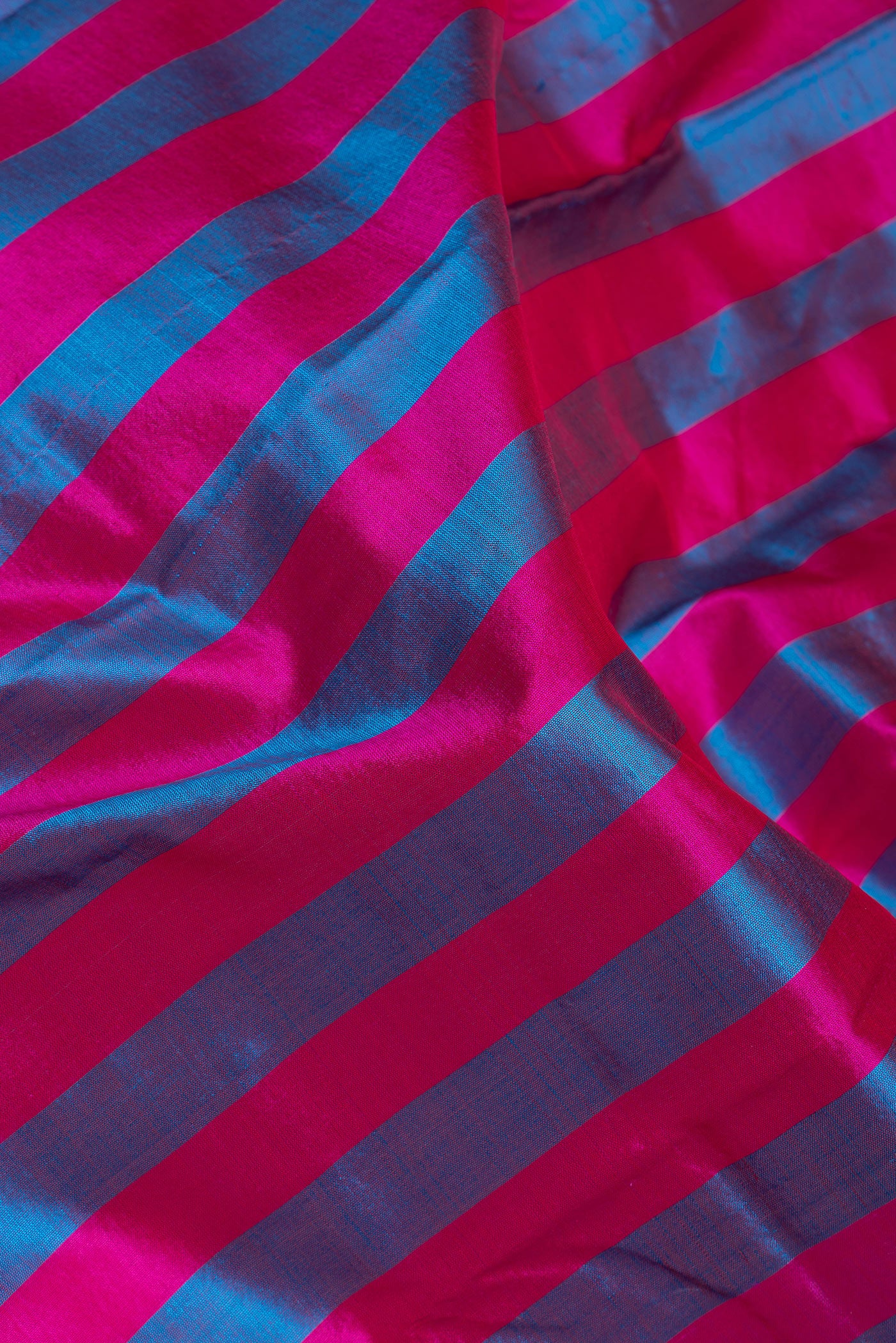 Close up of Multi Color Kanchipuram Silk Saree with Stripes on the body and Zari Border.  displaying folds