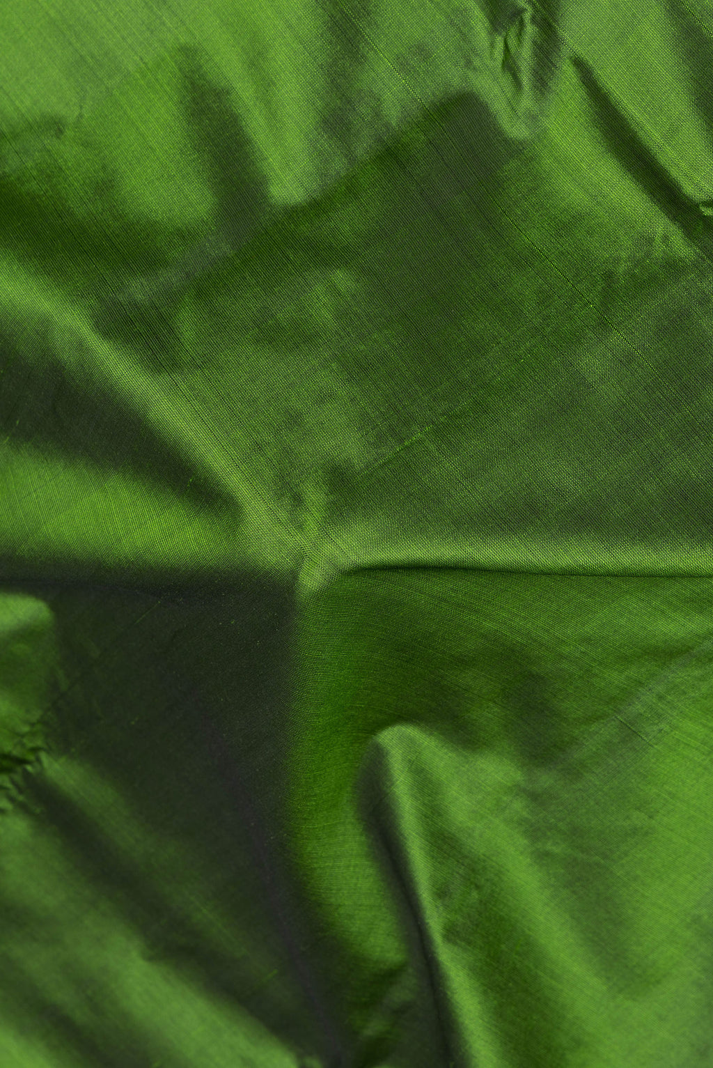 Close up of Mehandi Green Kanjivaram Silk Saree with Plain Body and Zari Border.  displaying folds