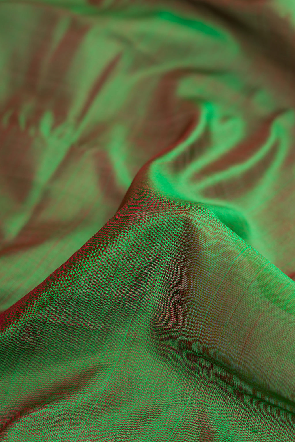 Close up of Bottle Green Dual Tone Kanchipuram Silk Nine Yards Saree with Thread Butta on the body and Thread Border.  displaying folds