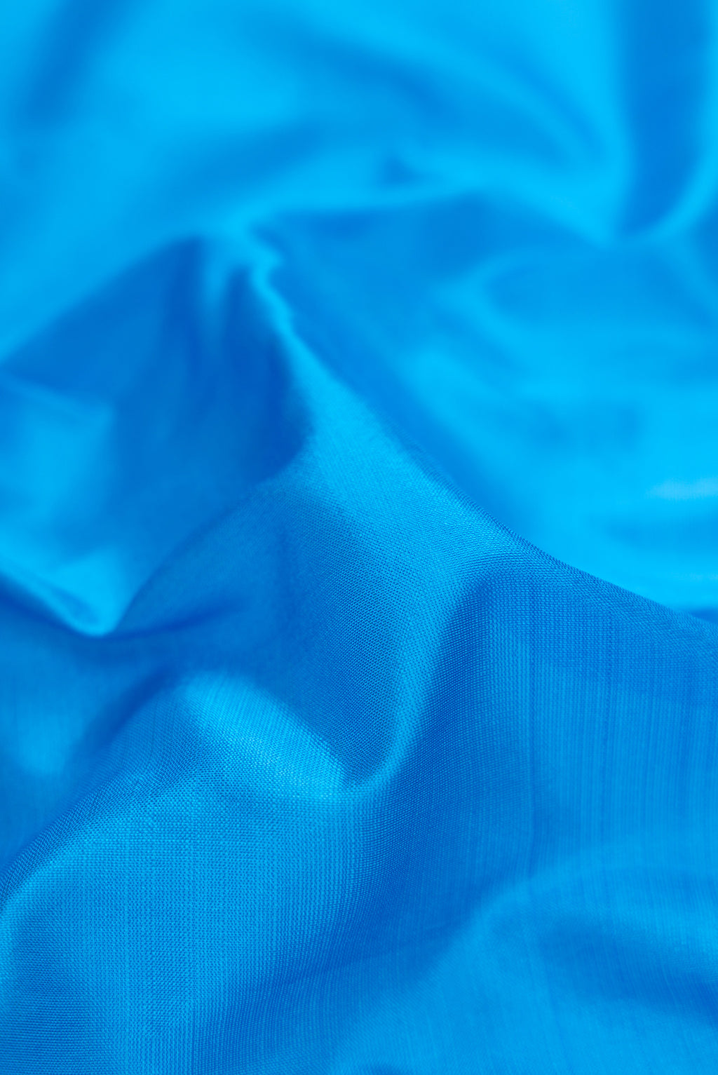 Close up of Sky Blue Dual Tone Kanchipuram Silk Nine Yards Saree with Thread Butta on the body and Thread Border.  displaying folds
