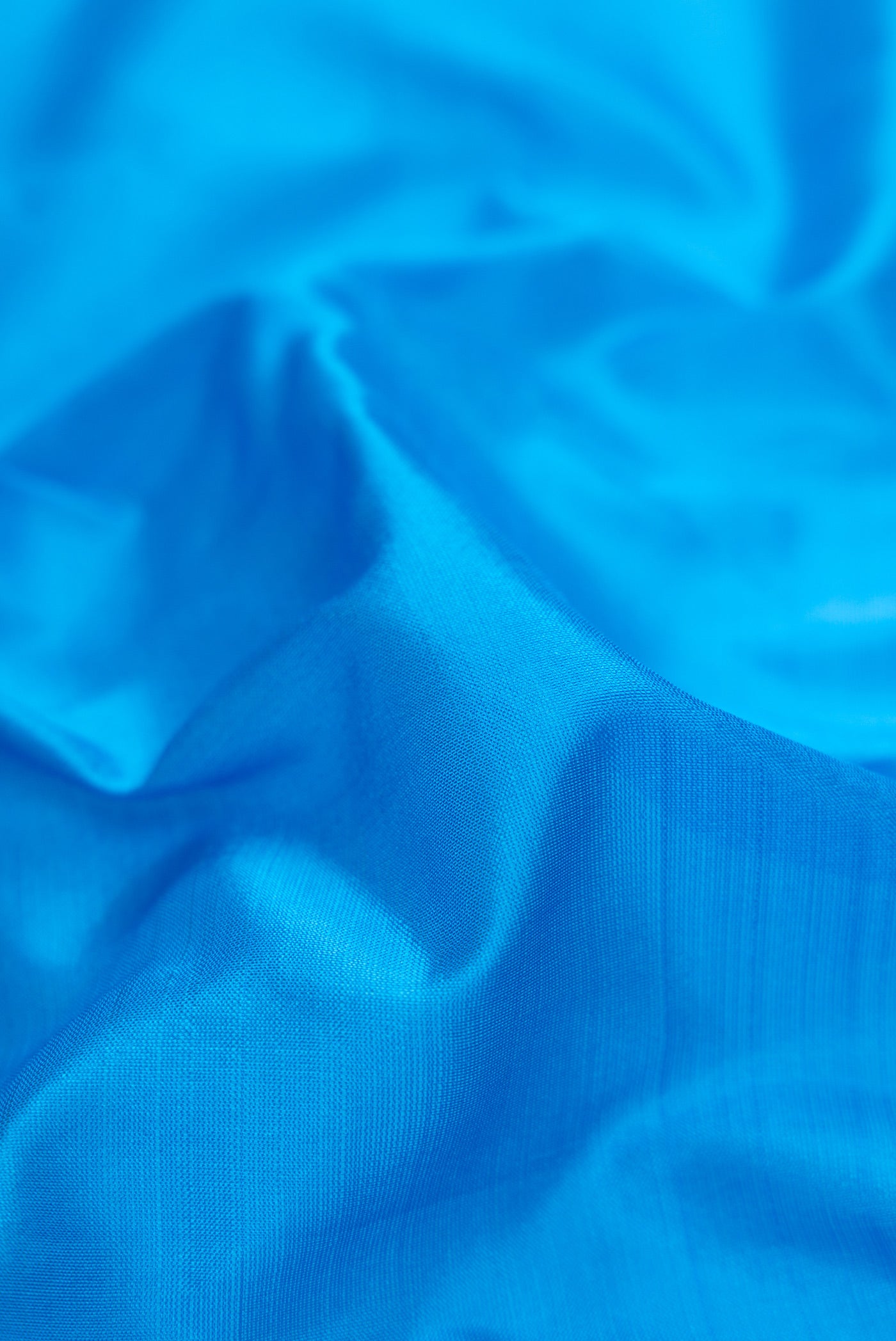 Close up of Sky Blue Dual Tone Kanchipuram Silk Nine Yards Saree with Thread Butta on the body and Thread Border.  displaying folds
