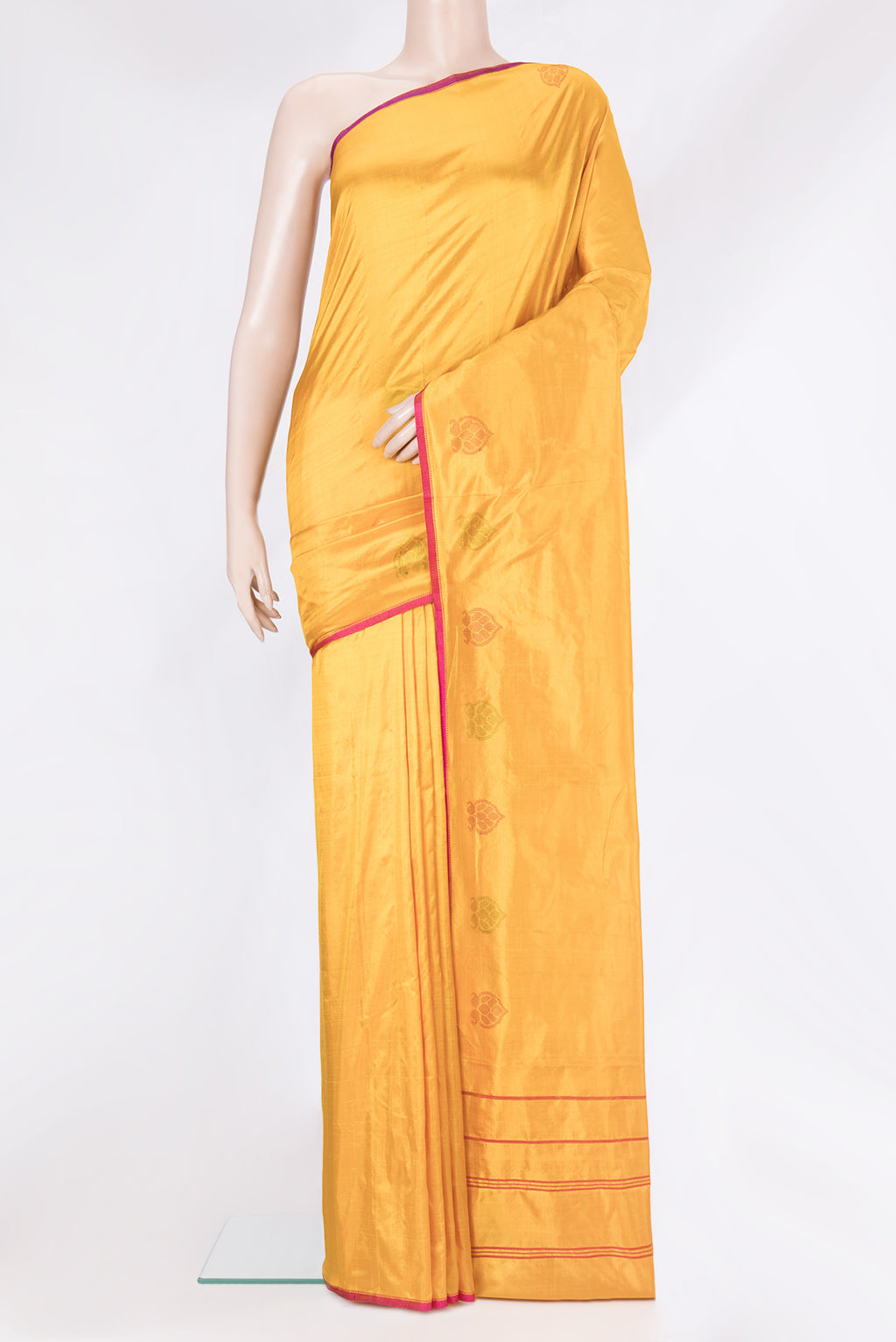 Mustard Kanchipuram Silk Saree with Plain Body and Fancy Border.  displayed on a mannequin