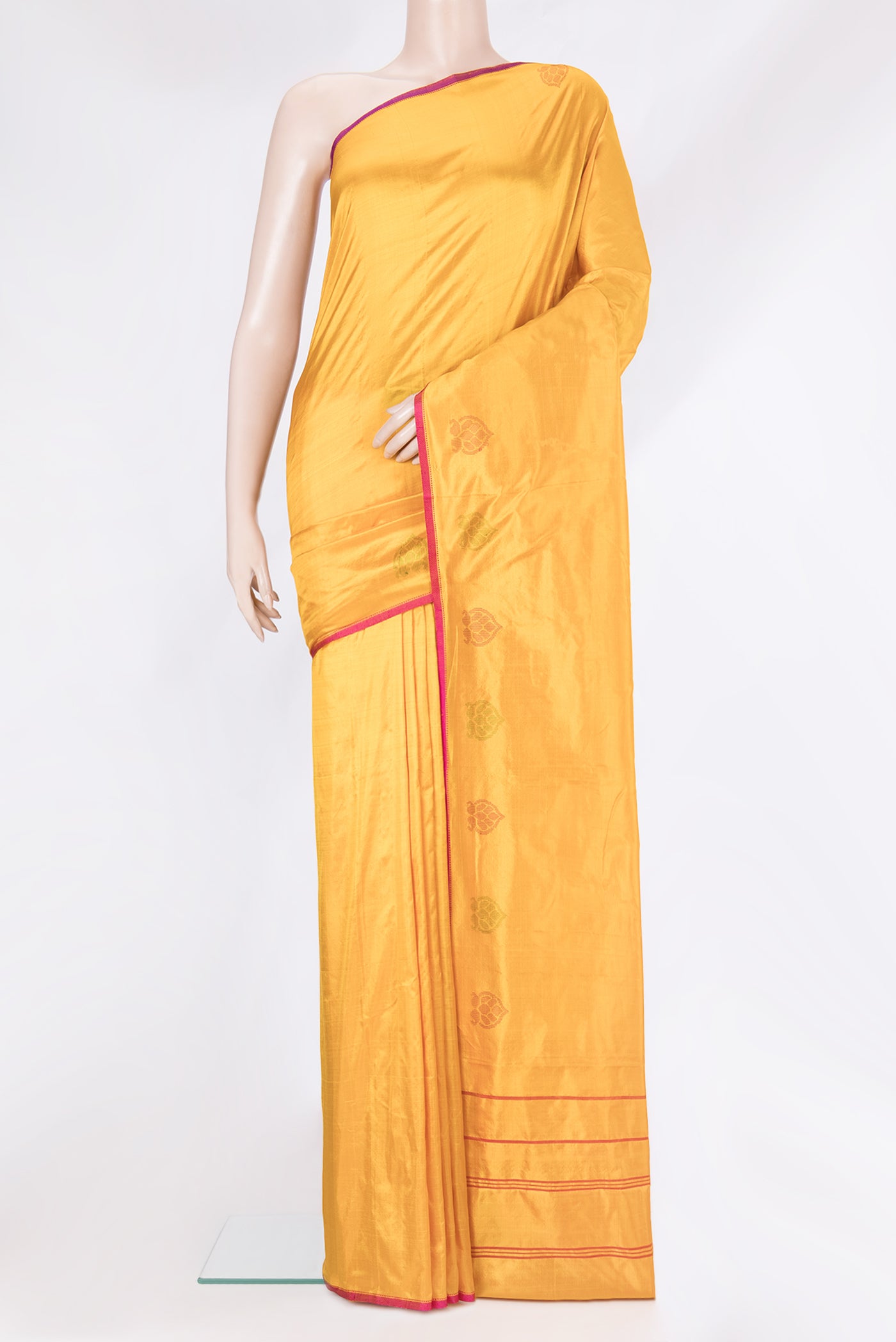 Mustard Kanchipuram Silk Saree with Plain Body and Fancy Border.  displayed on a mannequin
