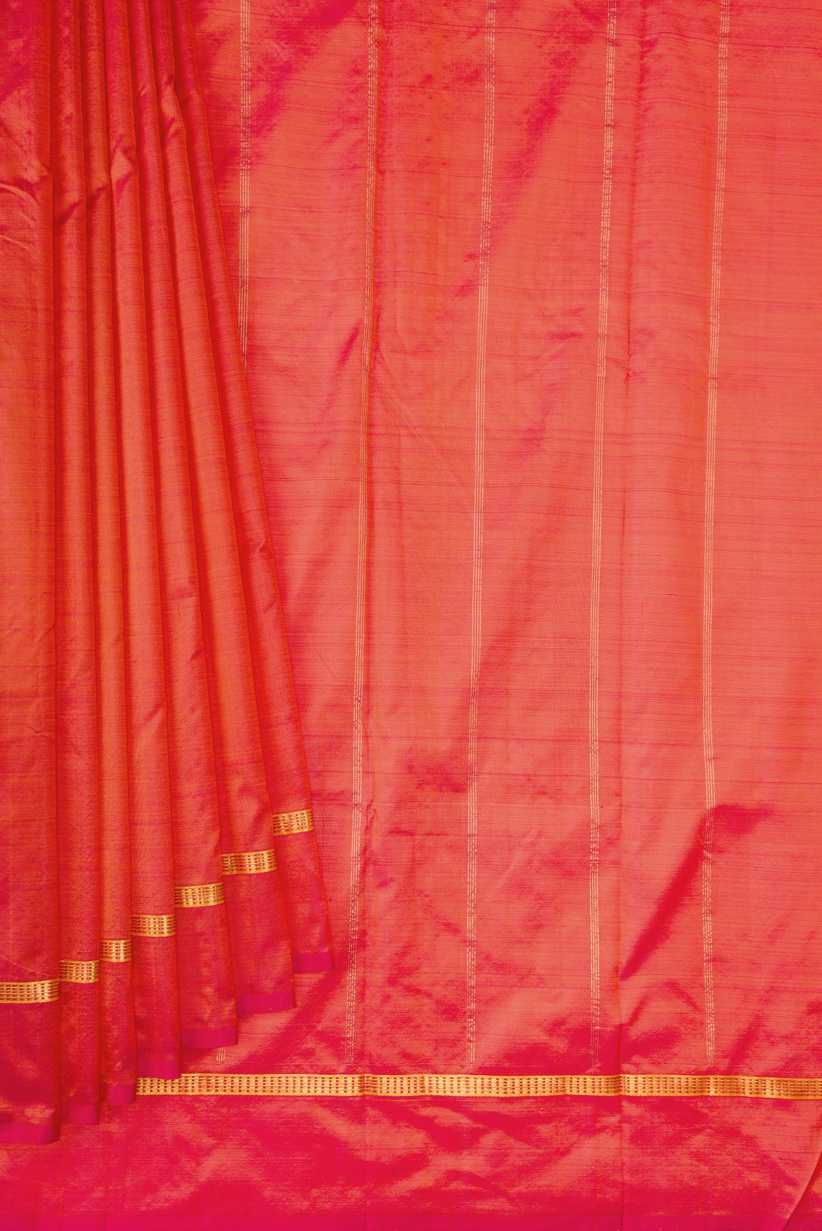 Pleats and pallu of Coral Dual Tone Kanchipuram Silk Saree with Plain Body and Zari Border. 