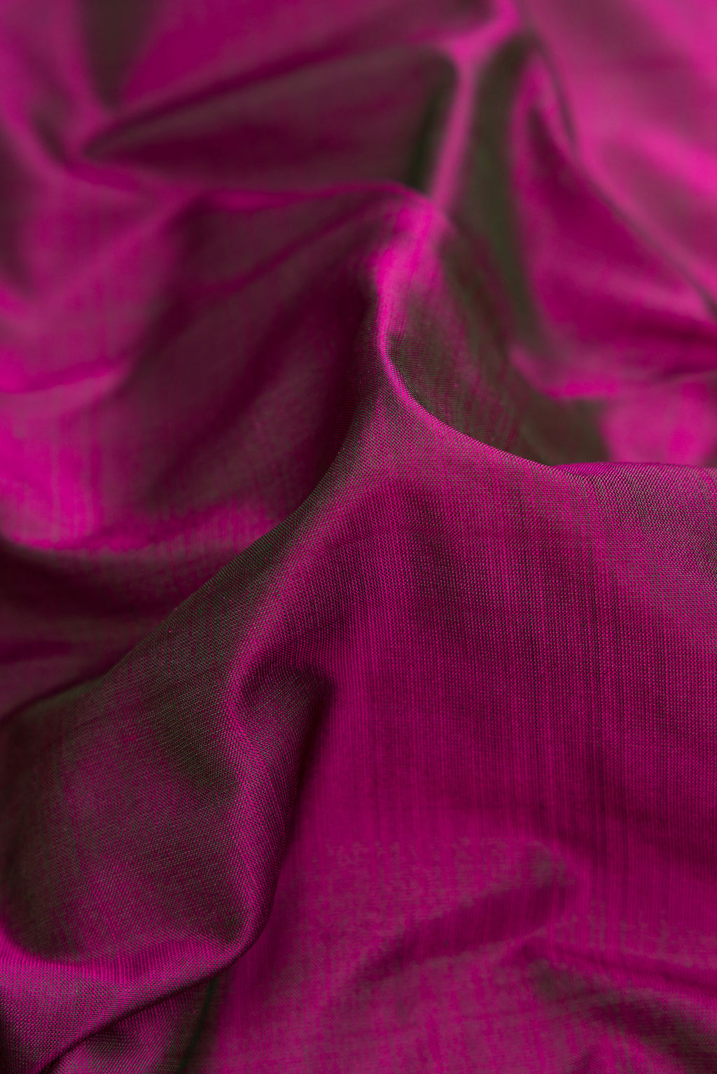 Close up of Purple Dual Tone Kanjivaram Silk Saree with Plain Body and Zari Border.  displaying folds