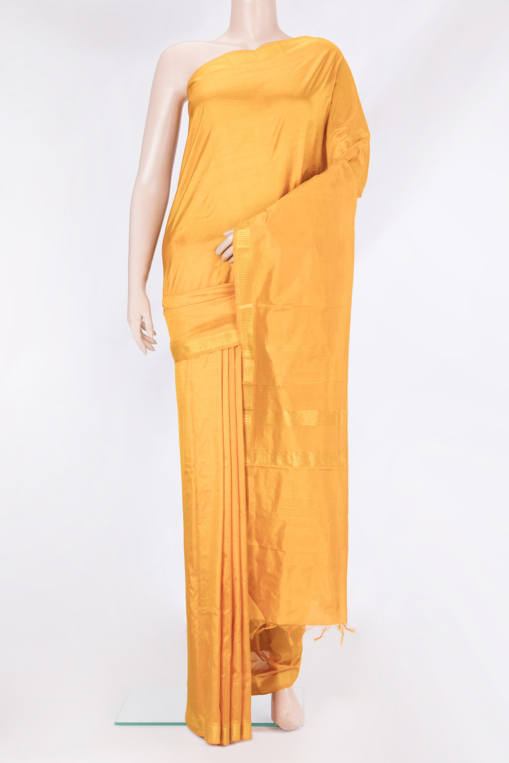 Mustard Kanjivaram Silk Saree with Plain Body and Zari Border.  displayed on a mannequin