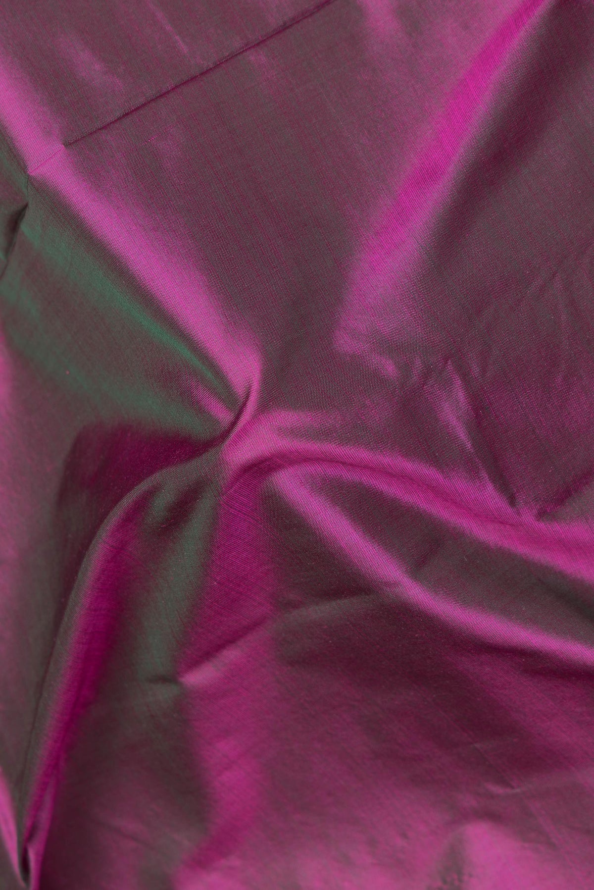 Close up of Pure Silk Purple Dual Tone Kanchipuram Saree with Plain Body and Zari Border.  displaying folds