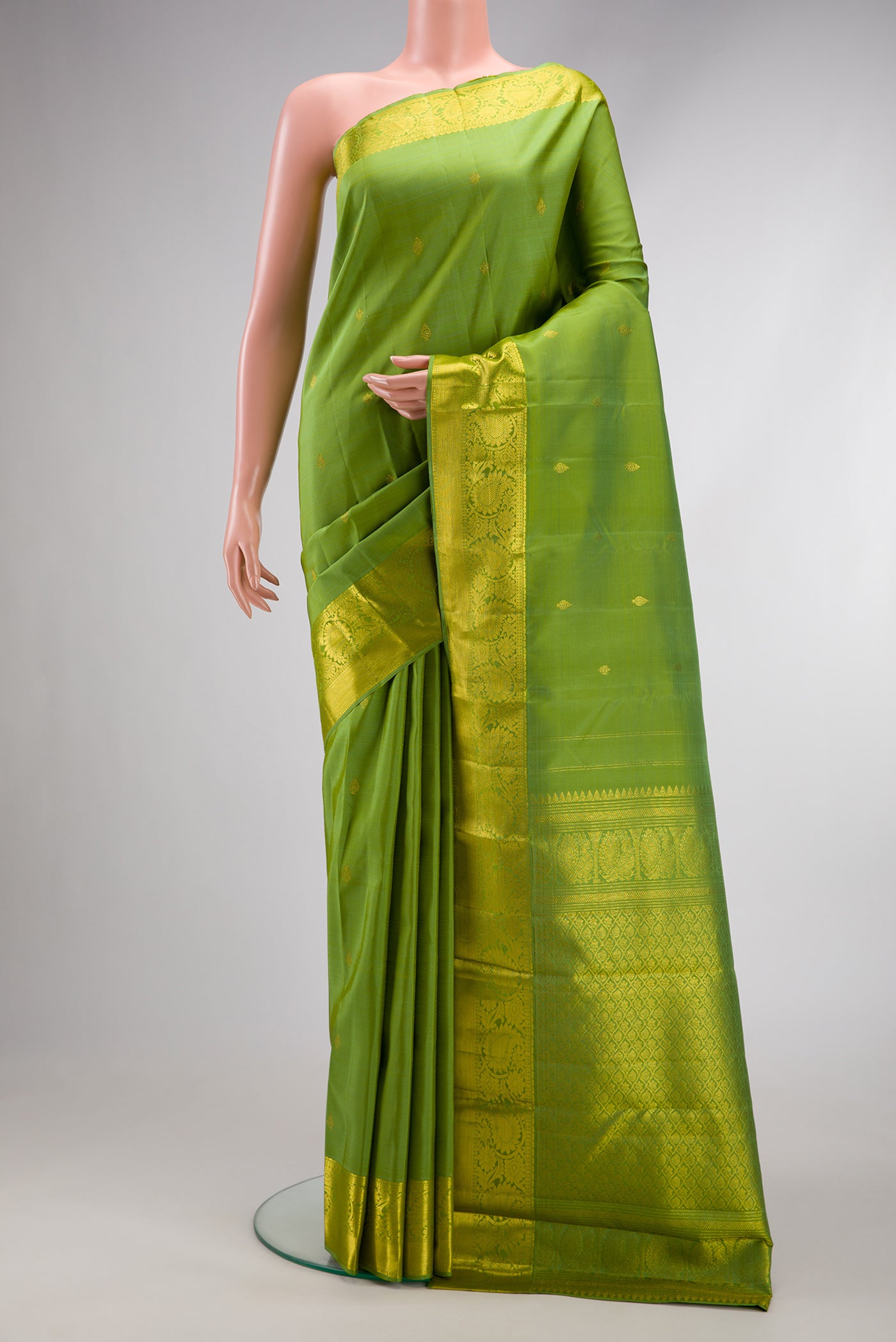 Light Green Dual Tone Kanjivaram Silk Saree with Zari Butta on the body and Zari Border.  displayed on a mannequin