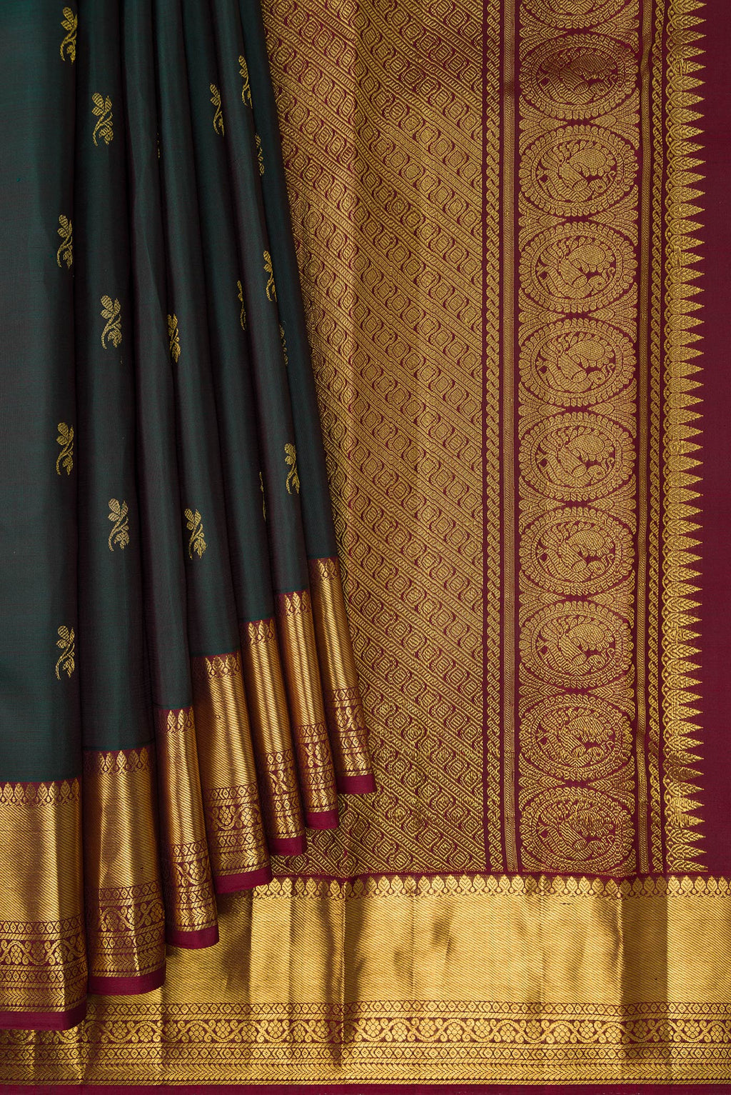 Pleats and pallu of Bottle Green Dual Tone Kanjivaram Silk Saree with Zari Butta on the body and Zari Border. 