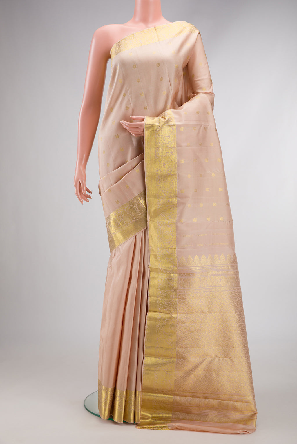 Beige Dual Tone Kanjivaram Silk Saree with Zari Butta on the body and Zari Border.  displayed on a mannequin