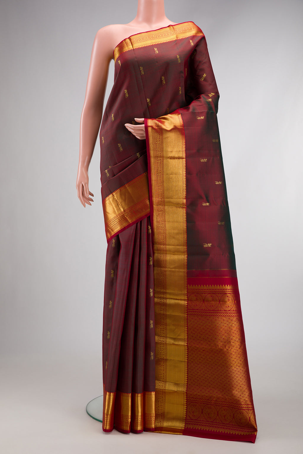 Maroon Dual Tone Kanjivaram Silk Saree with Zari Butta on the body and Zari Border.  displayed on a mannequin