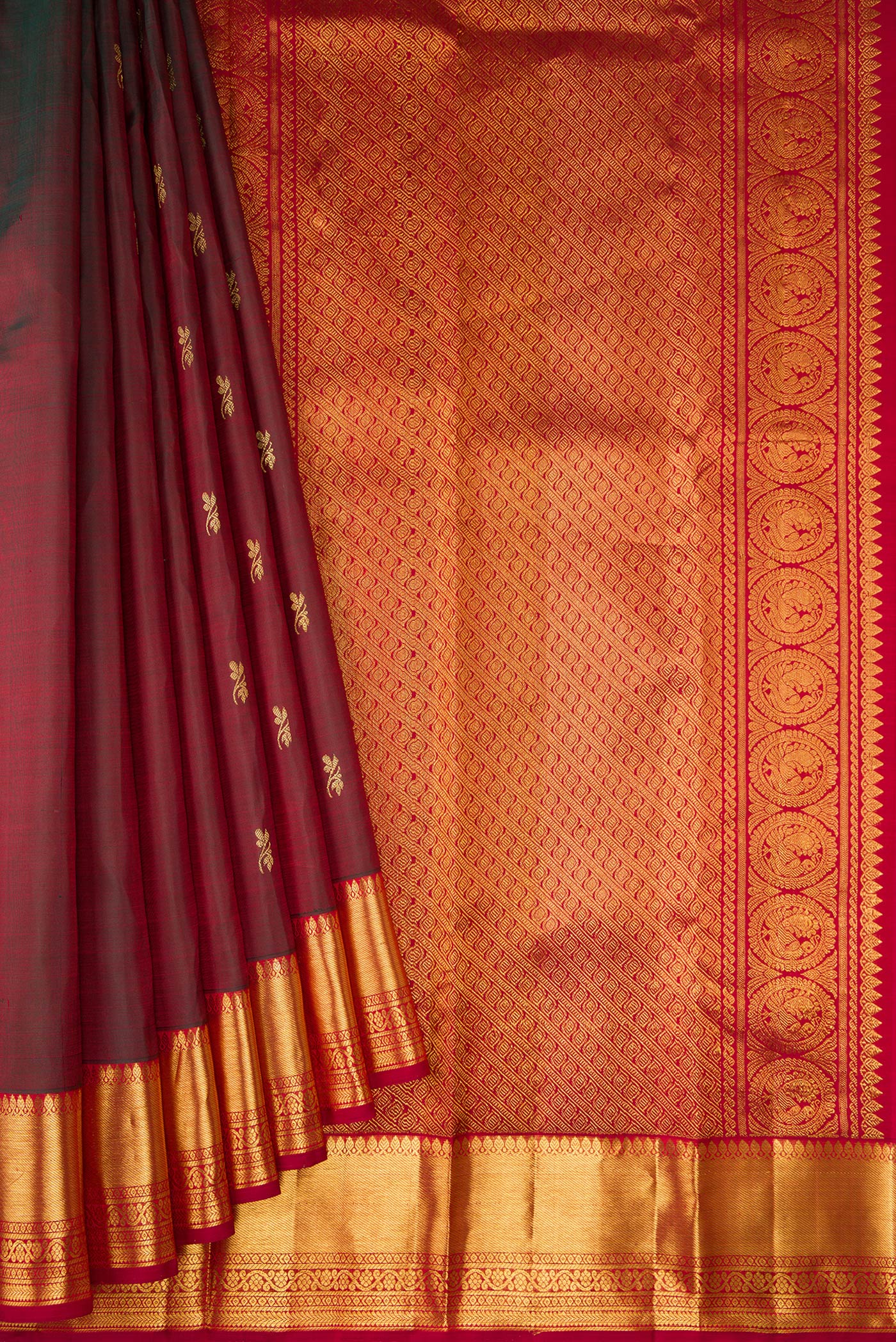 Pleats and pallu of Maroon Dual Tone Kanjivaram Silk Saree with Zari Butta on the body and Zari Border. 